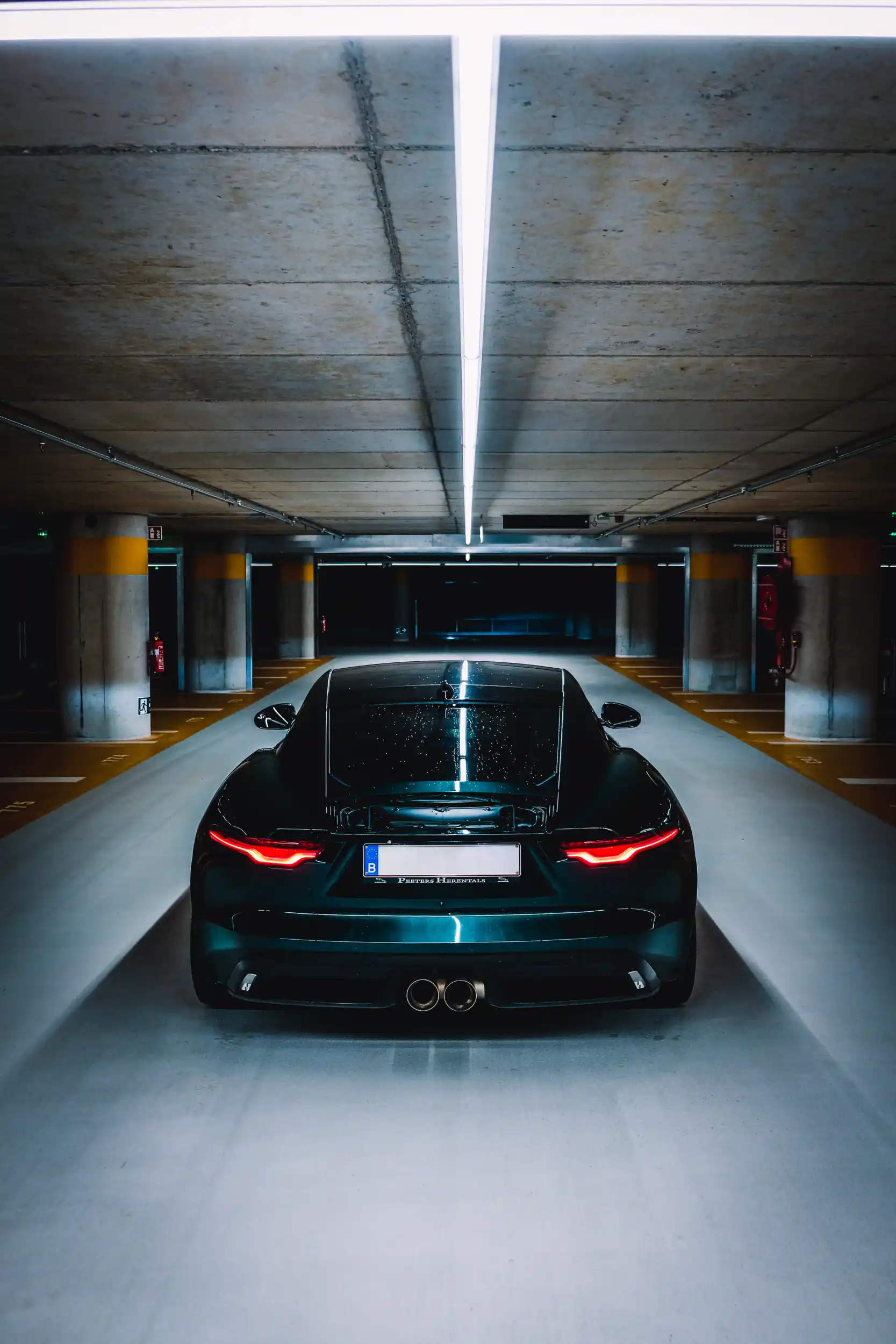 British Racing Green Jaguar F-Type in an underground parking garage. Featured image for Jaguar Belgium.