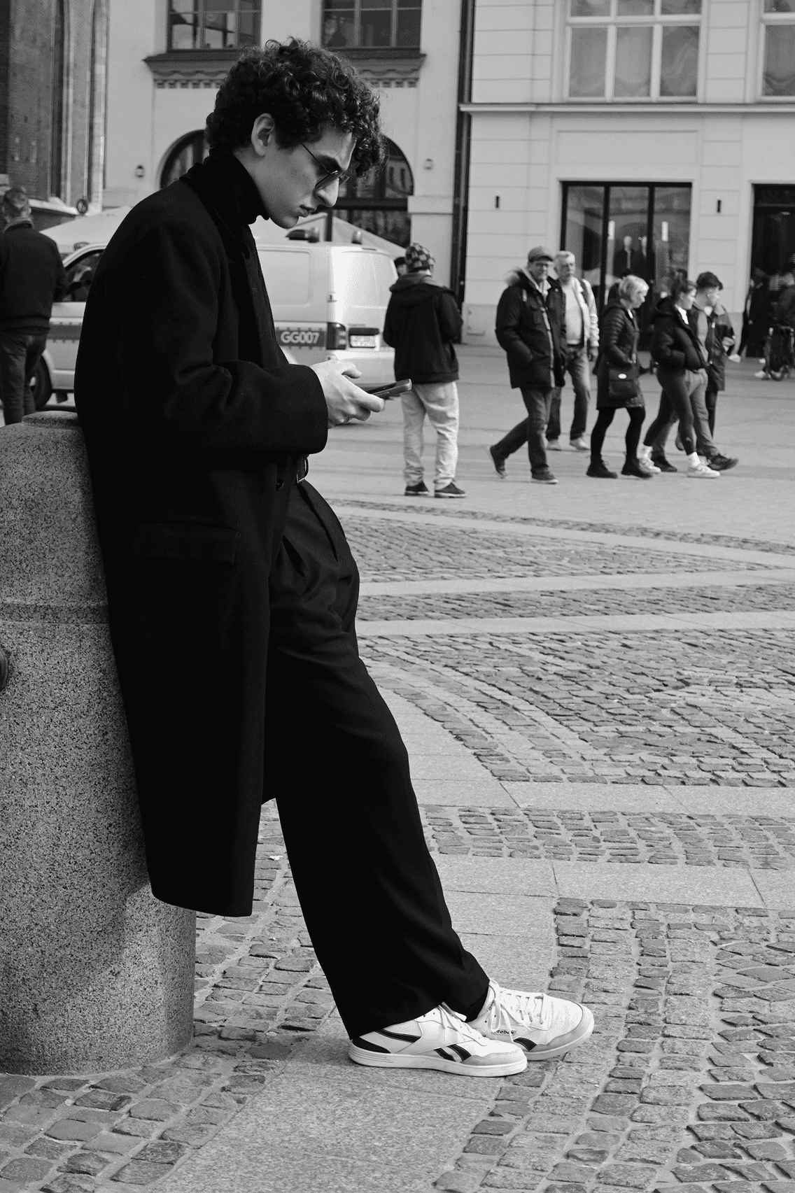 A stack of magazines with red borders arranged in a row, viewed from a low angle.