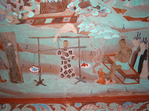 Mogao Caves: Detail of a painted mural scene inside a cave temple at the Buddhist rock‑cut sanctuary near Dunhuang, Gansu Province, China