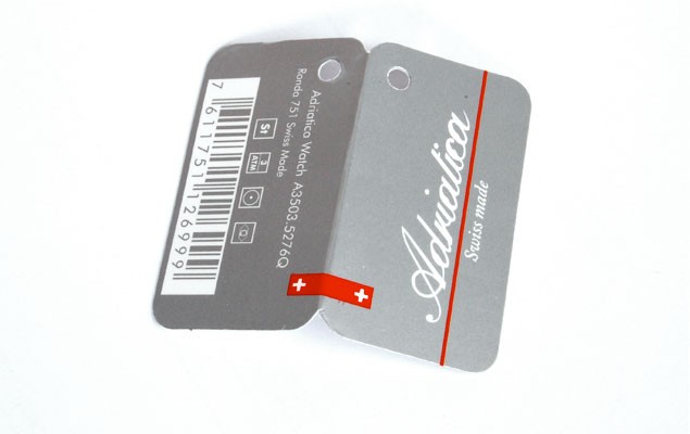 Adriatica folded hang tags – front with brand identity, reverse with EAN barcode, model reference and technical specification icons. Minimum production run: 100 per model.