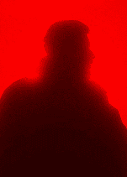 headshot of male in dark background