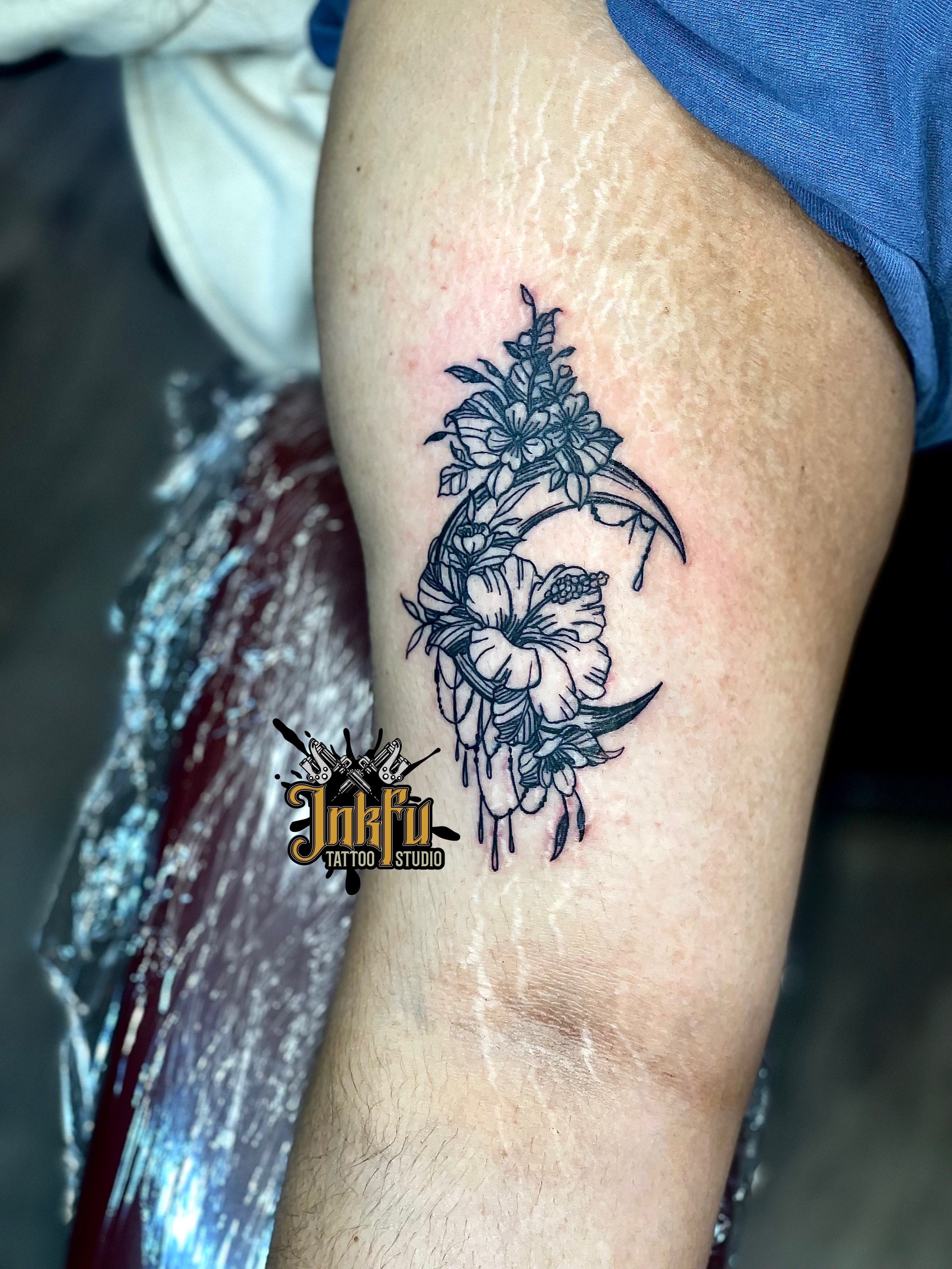 Fine line floral crescent moon tattoo on the inner arm, by Meer Rich