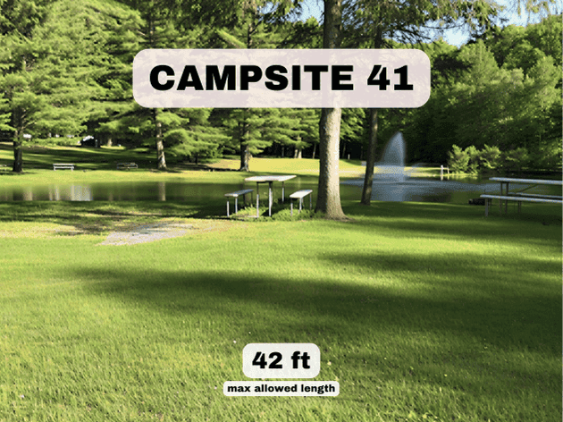 "Campsite 41 at Pine Hollow Campground, a 42ft pondfront RV site with a picnic table and scenic fountain views