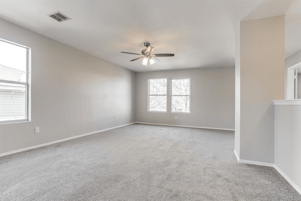 Modern flexible living space addition in Dallas, Texas with new carpeting, natural light, ceiling fan, and open layout designed for multi-use living.