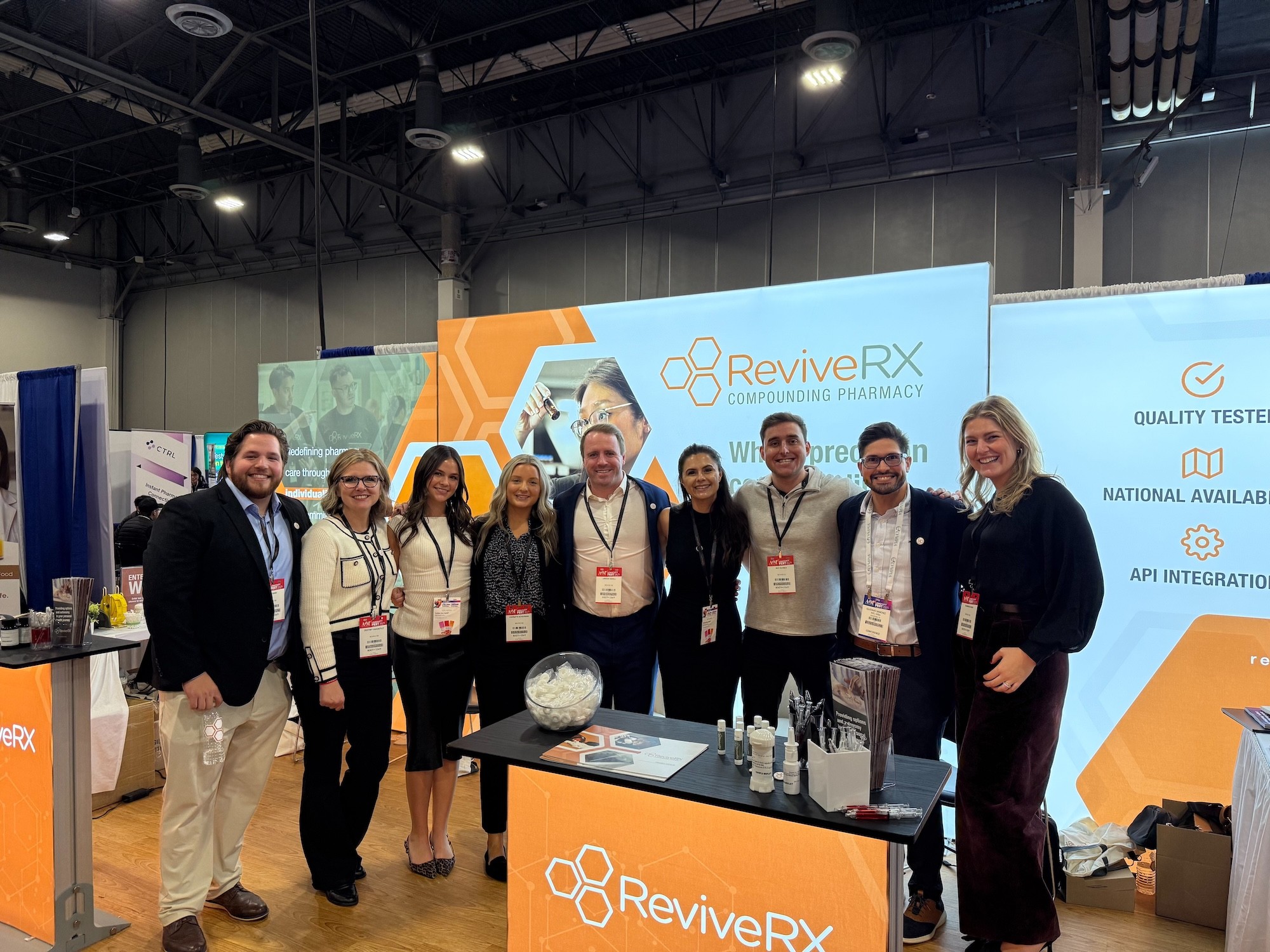 A large group of smiling employees posing for a picture in an office