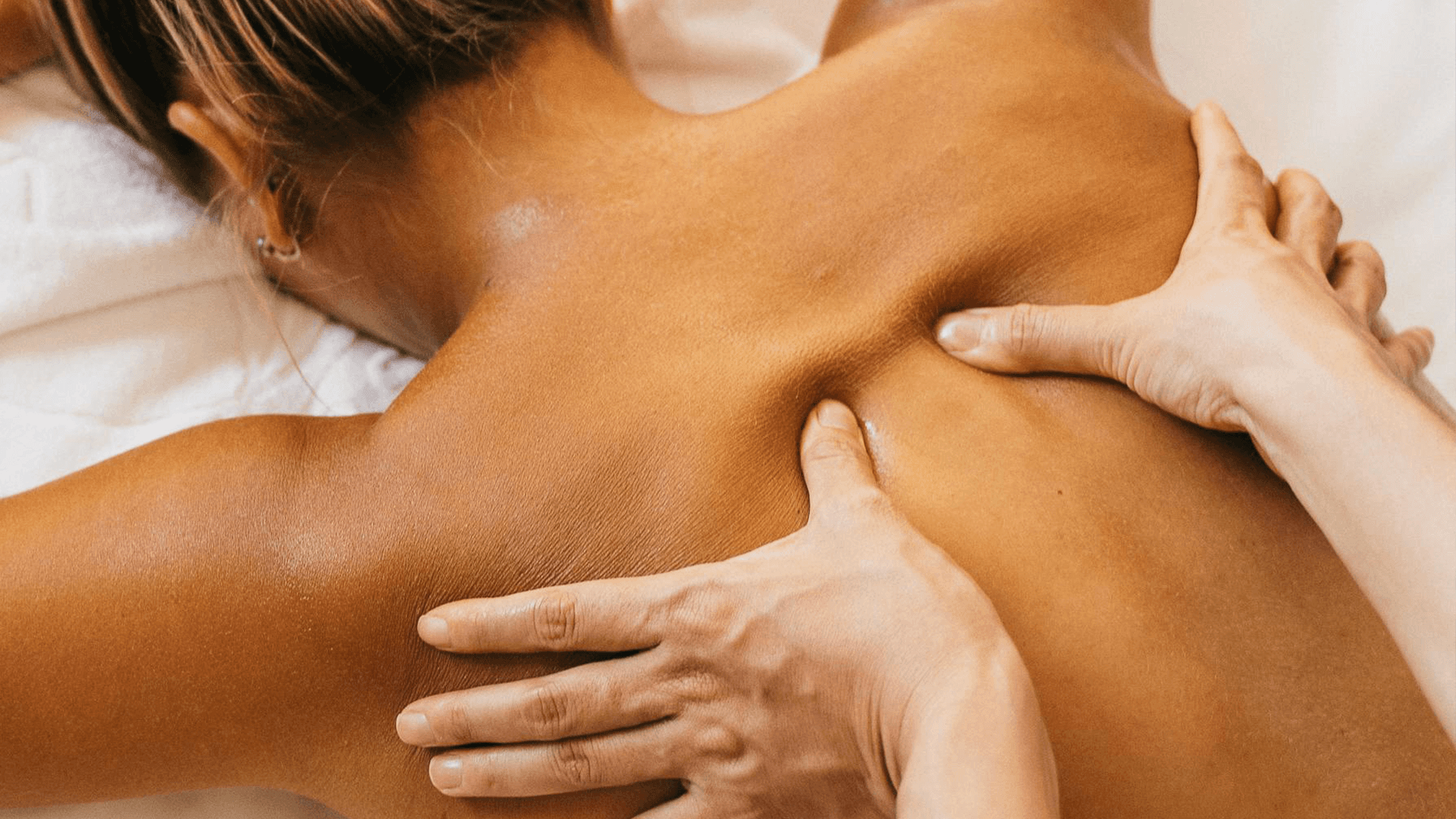 woman holding a phone and man looking at the phone. both are smiling