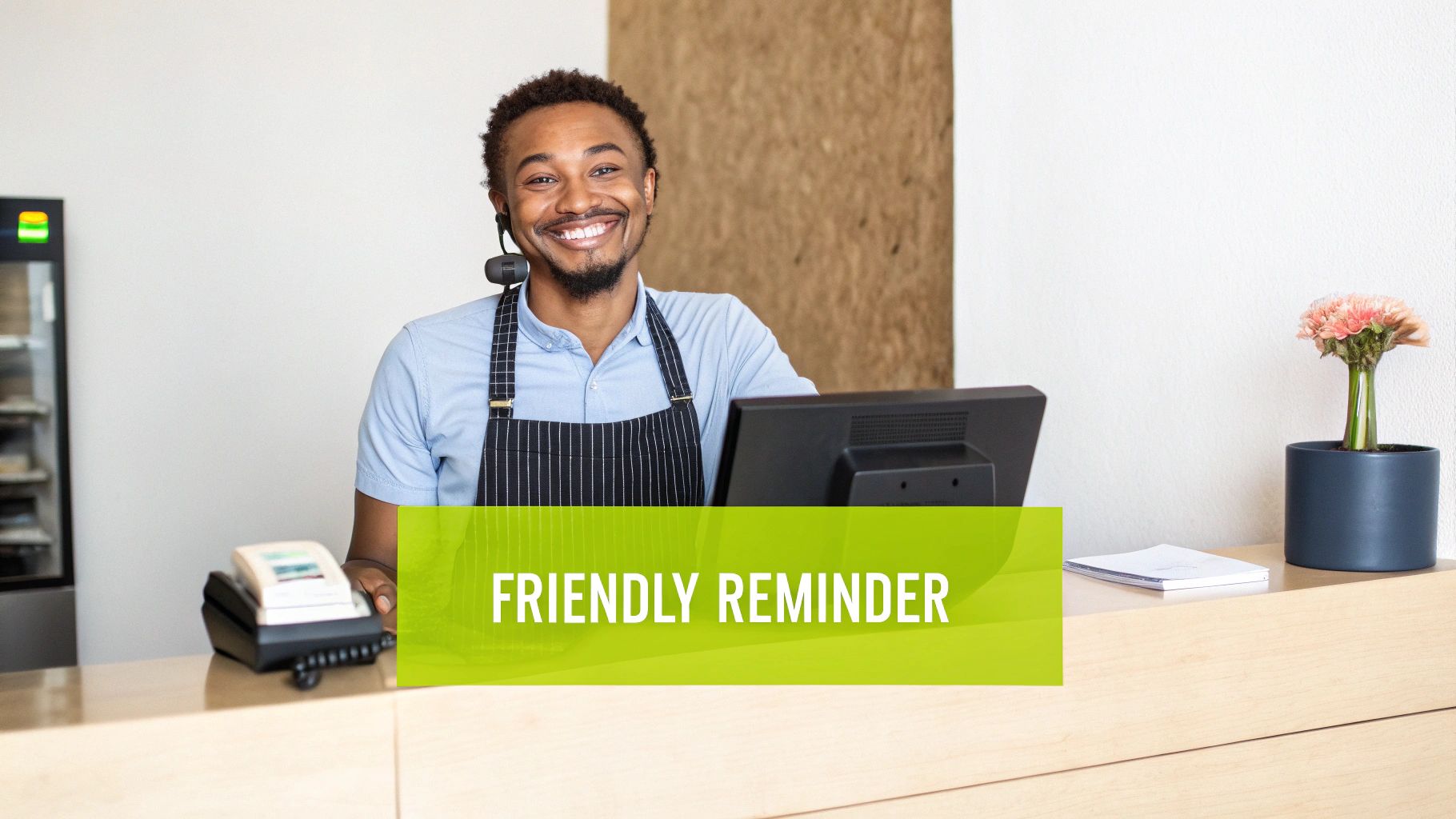 Smiling Black man in an apron and headset at a counter, with a 'FRIENDLY REMINDER' text overlay.