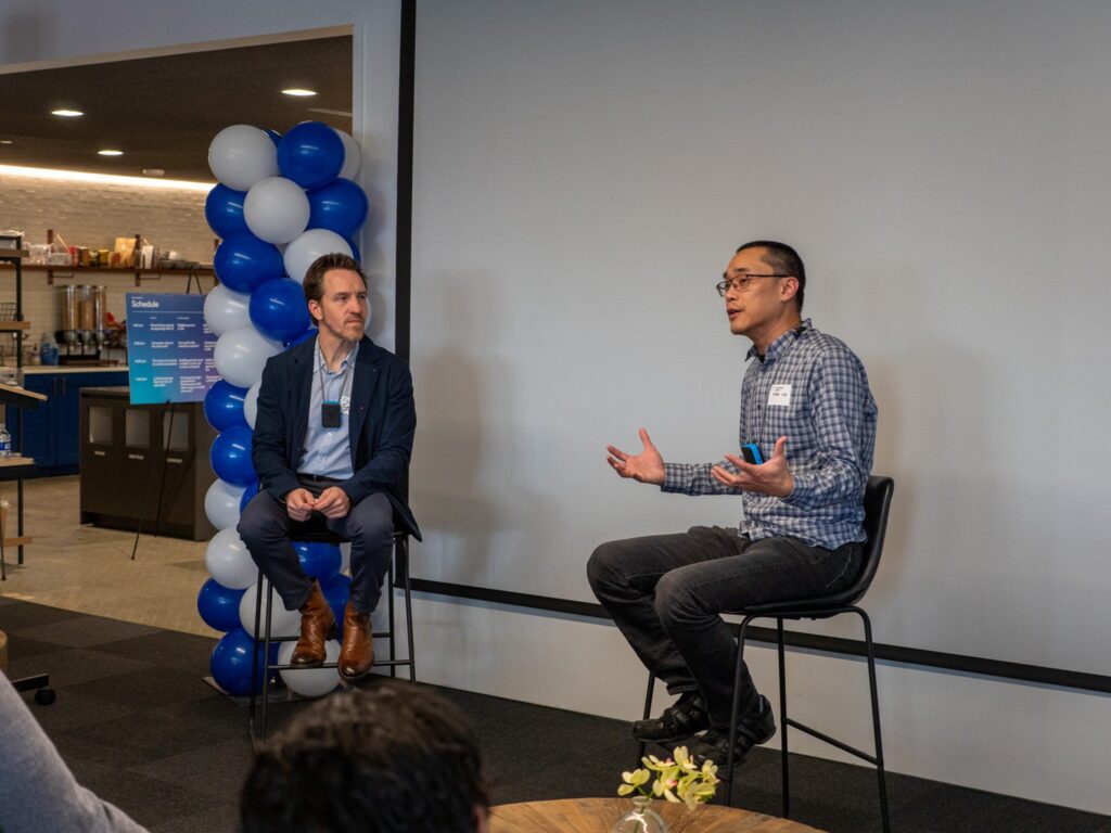 Steve vassalo engaged in a conversation, leading the conference talks