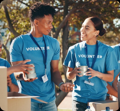 Two cheerful young people, man and women smiling and volunteering