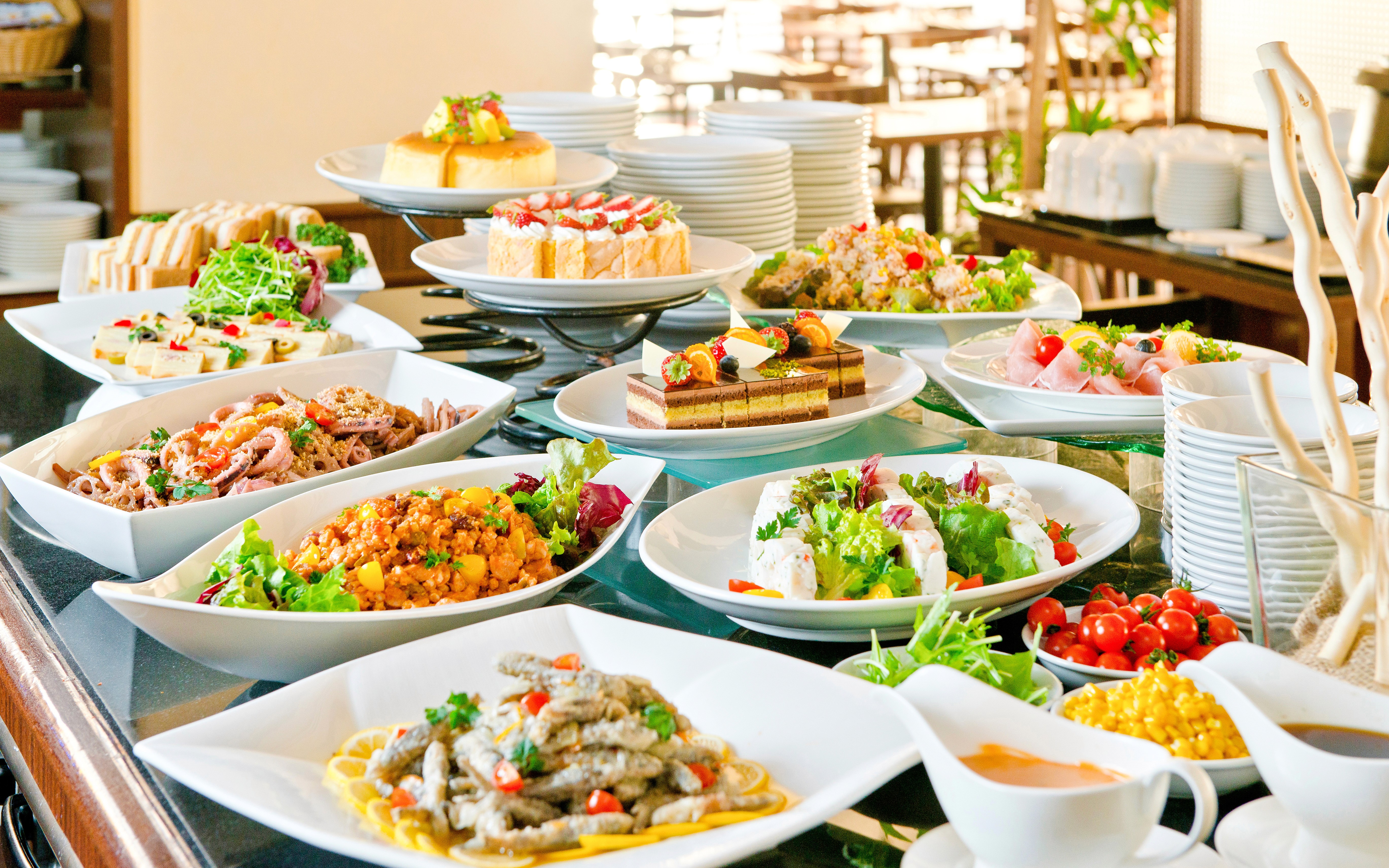 Buffet spread with various dishes at a lunch event in a scenic outdoor setting.
