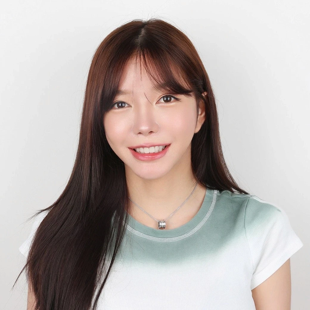 Woman with long dark hair smiling after ceramic veneer treatment