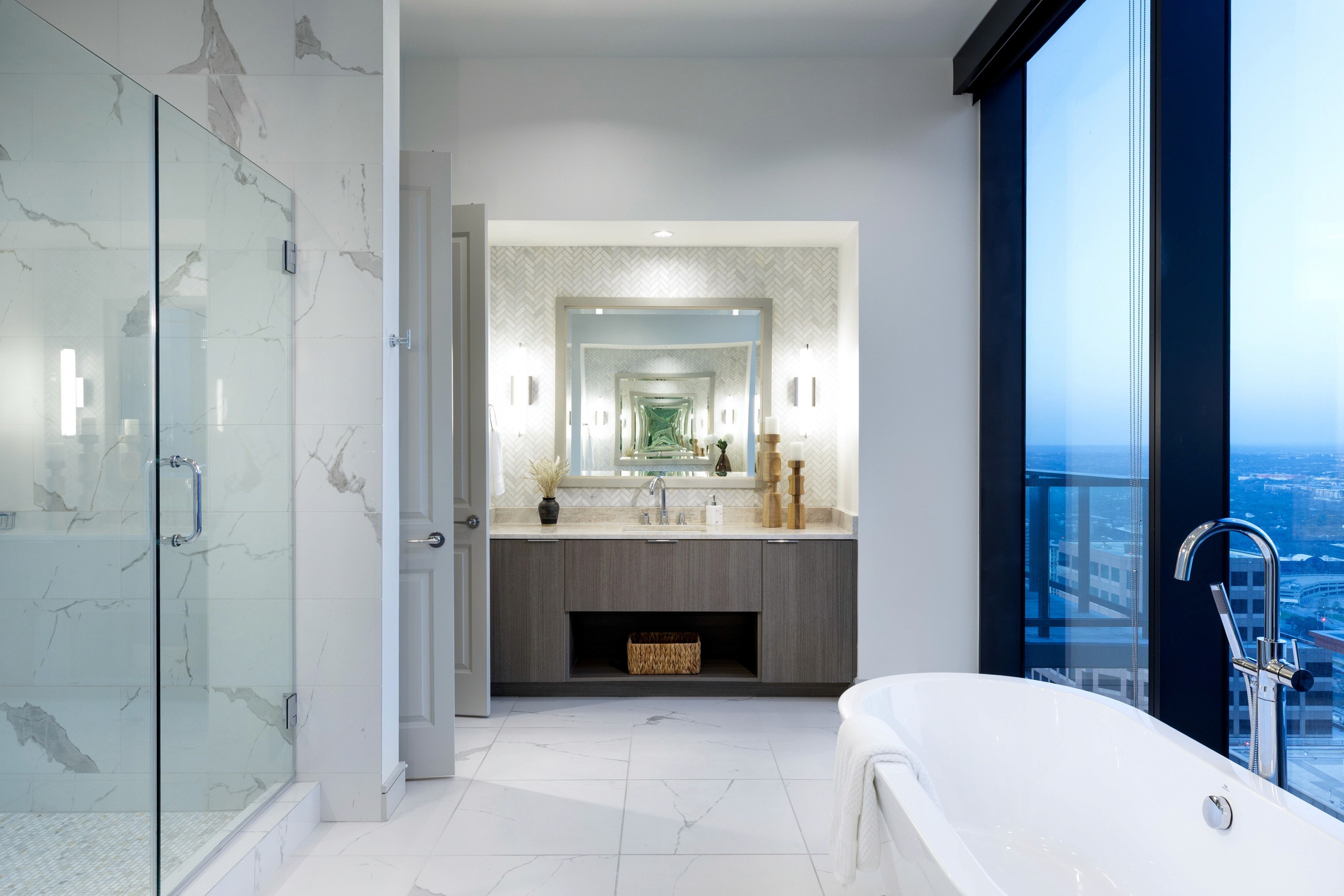Modern bathroom with marble tiles, glass shower