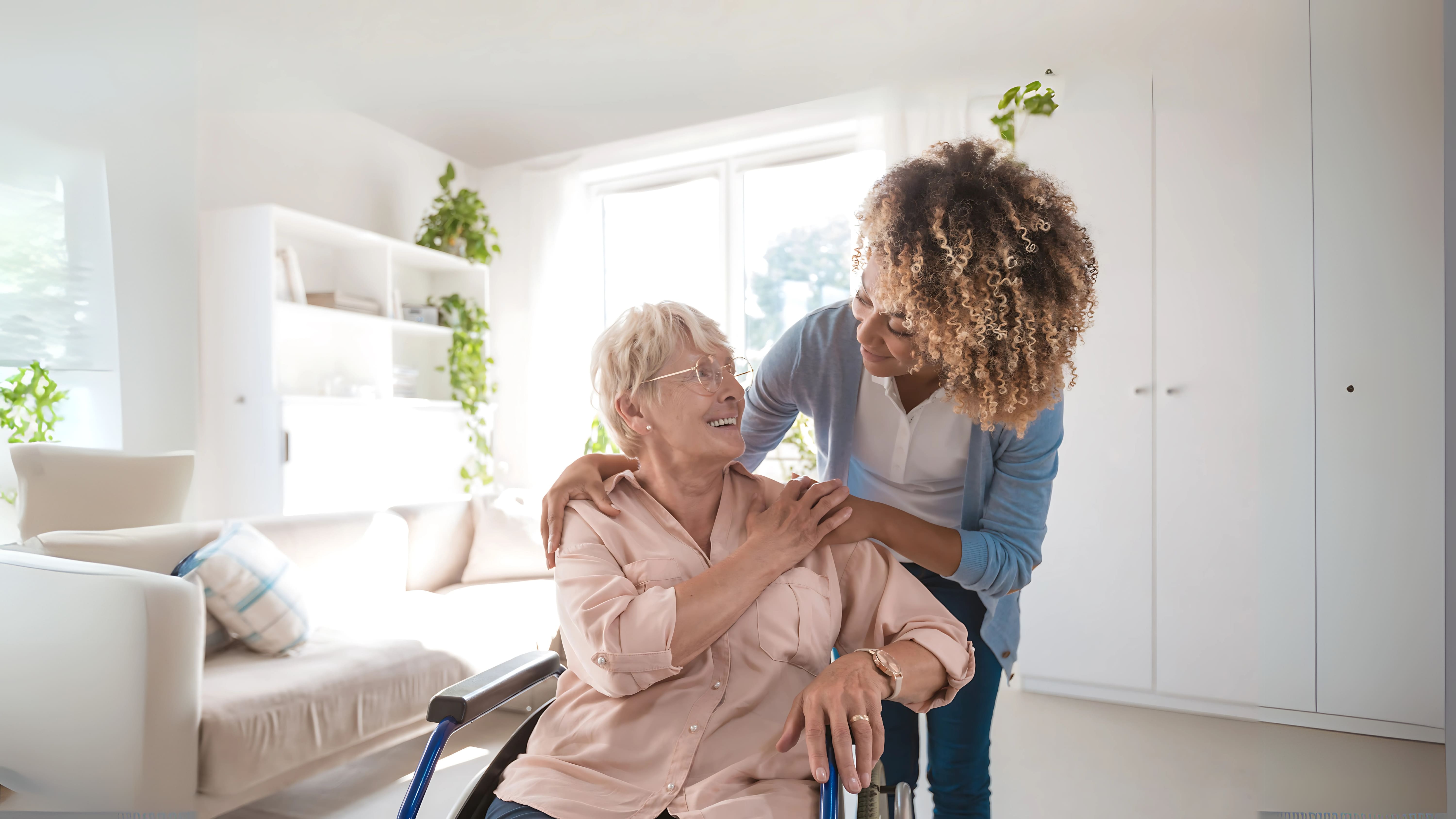 Caregiver comforting an elderly woman, representing the millions of overwhelmed caregivers.