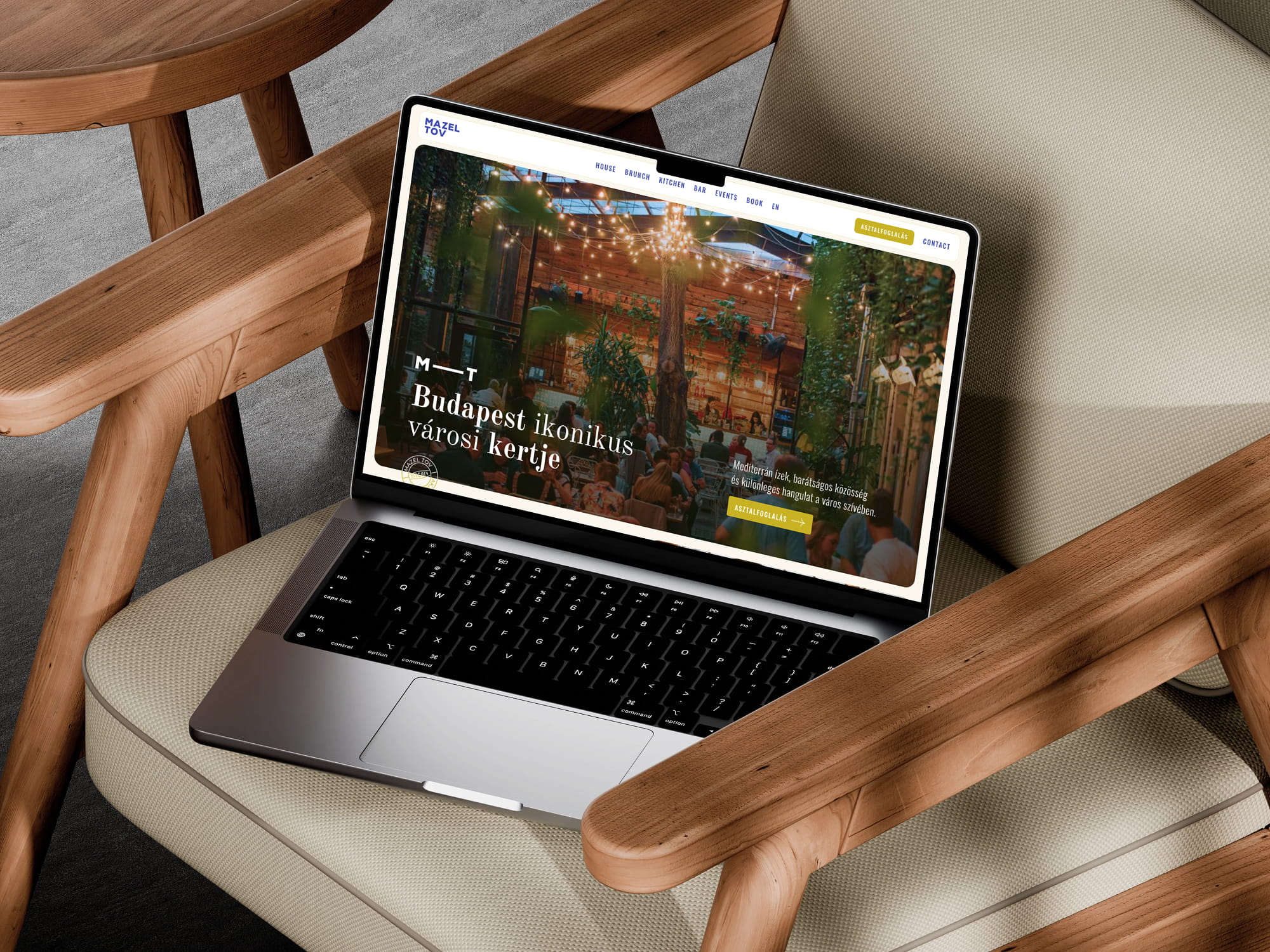 Mazel Tov website on laptop in outdoor seating area