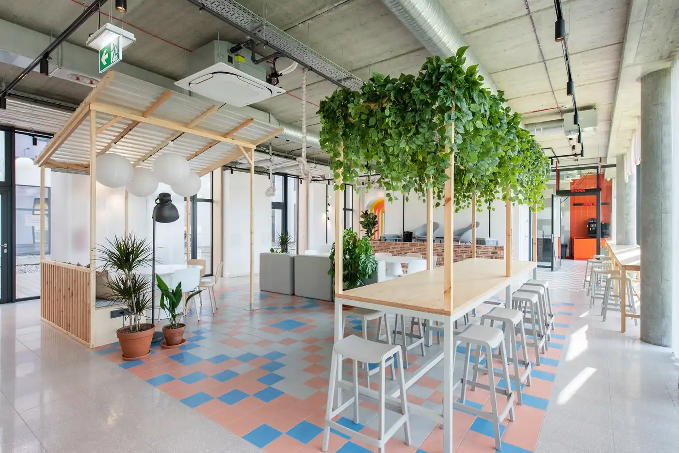Communal kitchen and dining area in Vilnius student accommodation with shared tables and seating.
