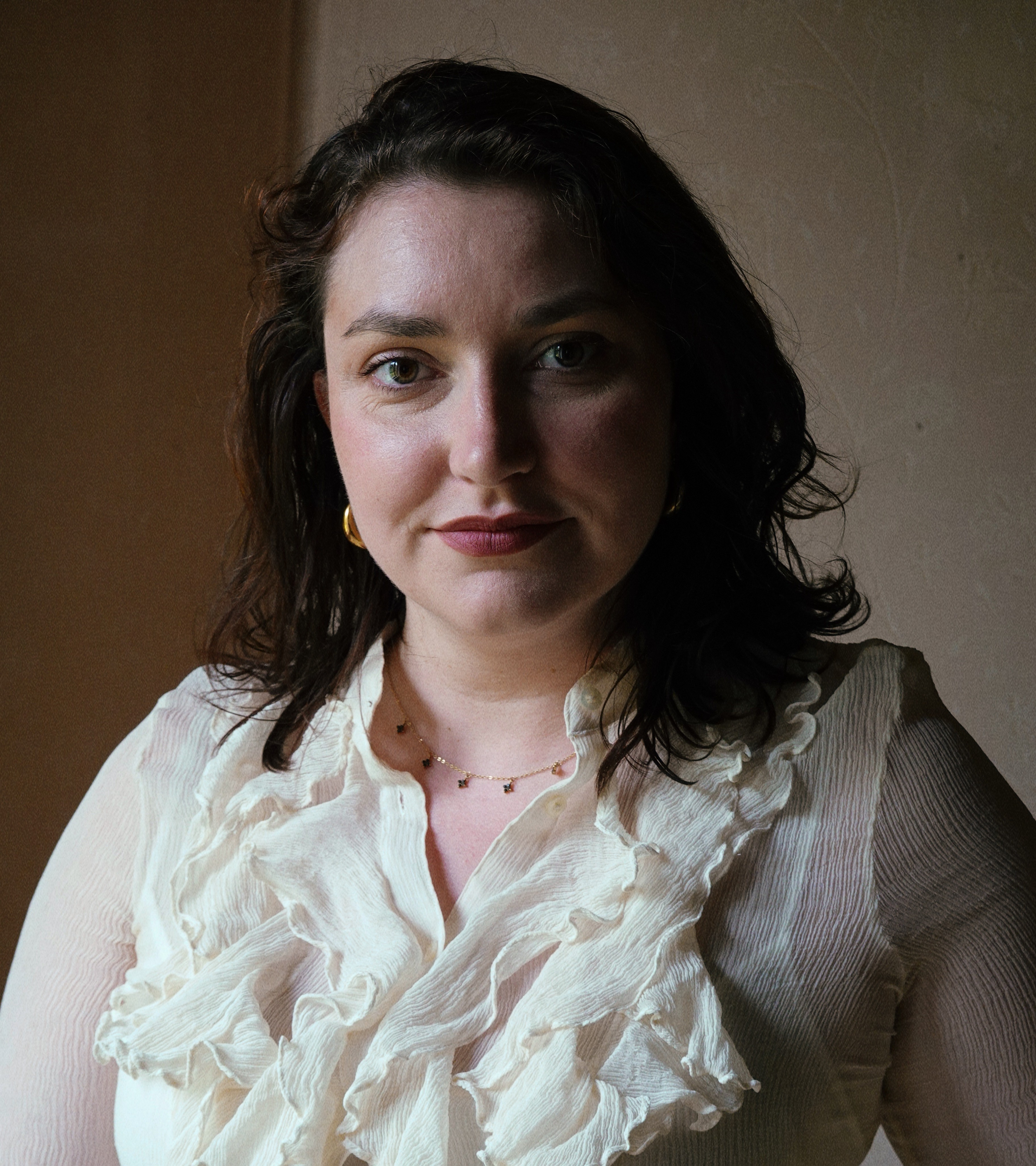 A woman sitting in a photo studio