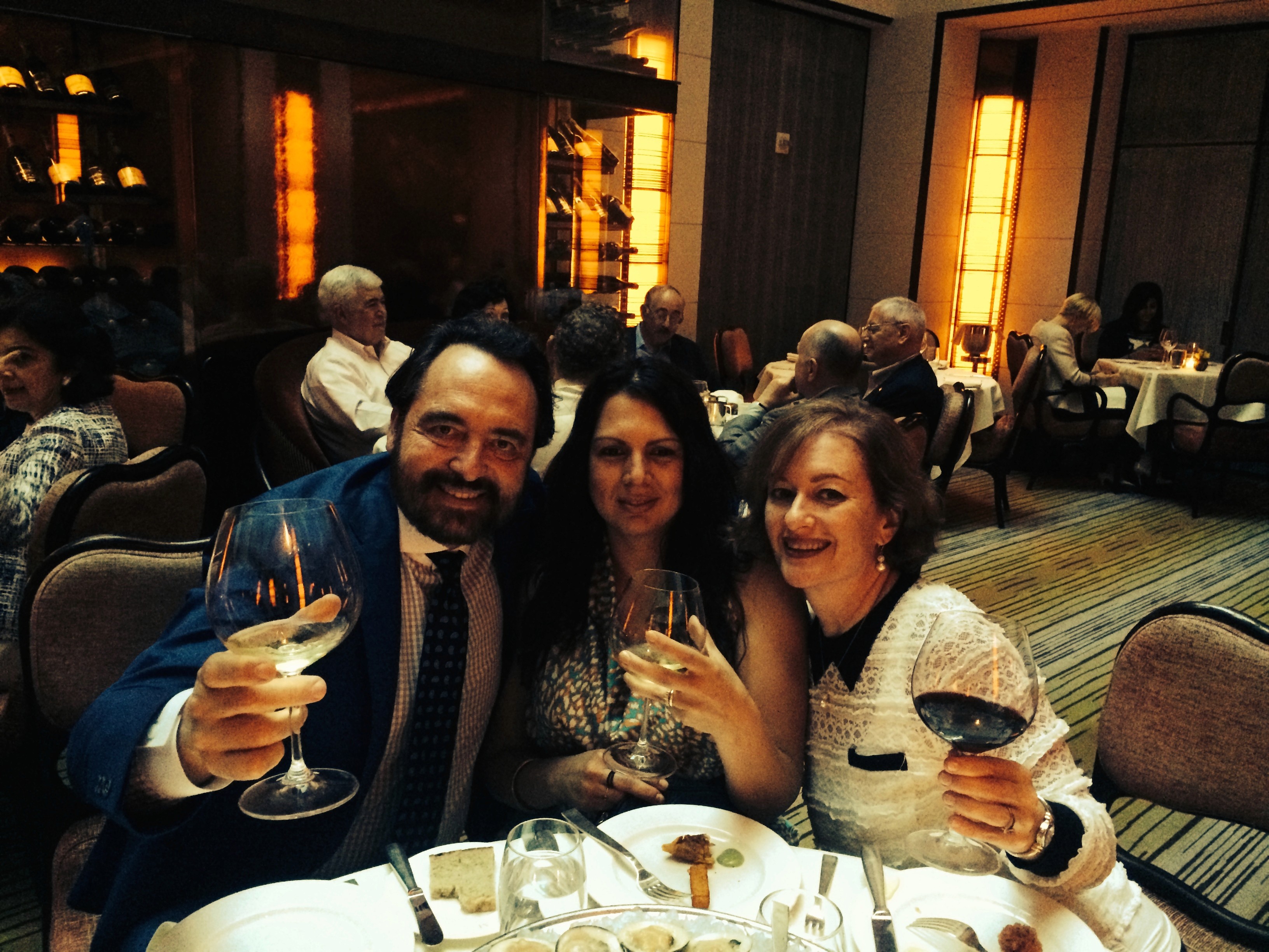 author with friends in a restaurant raising a glass