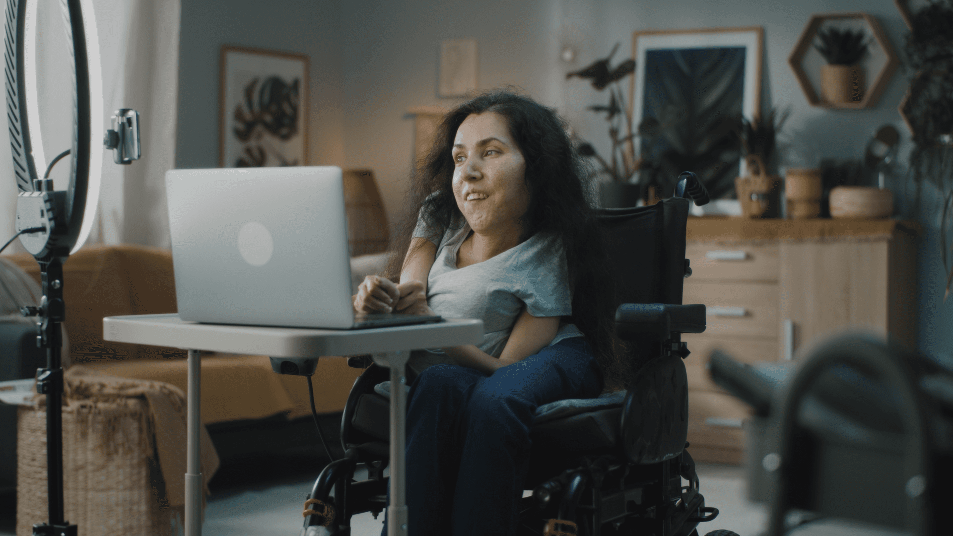 A woman with a disability using her computer.