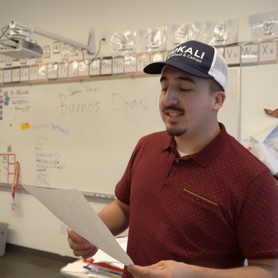 Language instructor teaching beginner Spanish to students in enrichment workshop