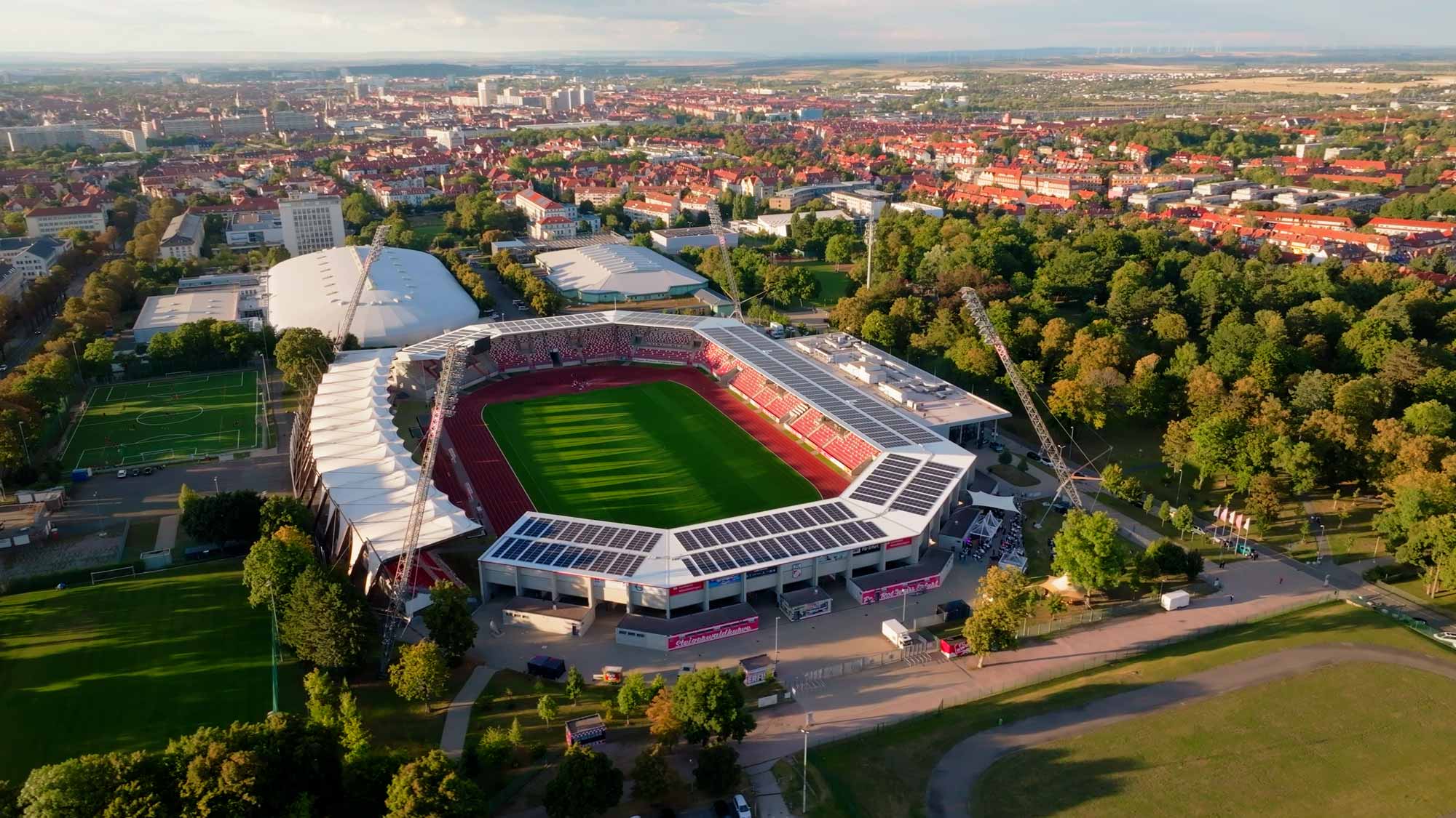 Aerial view of a stadium surrounded by lush greenery, , captured for imagefilm