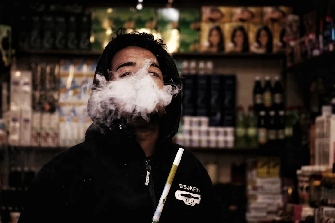 man smoking inside bar
