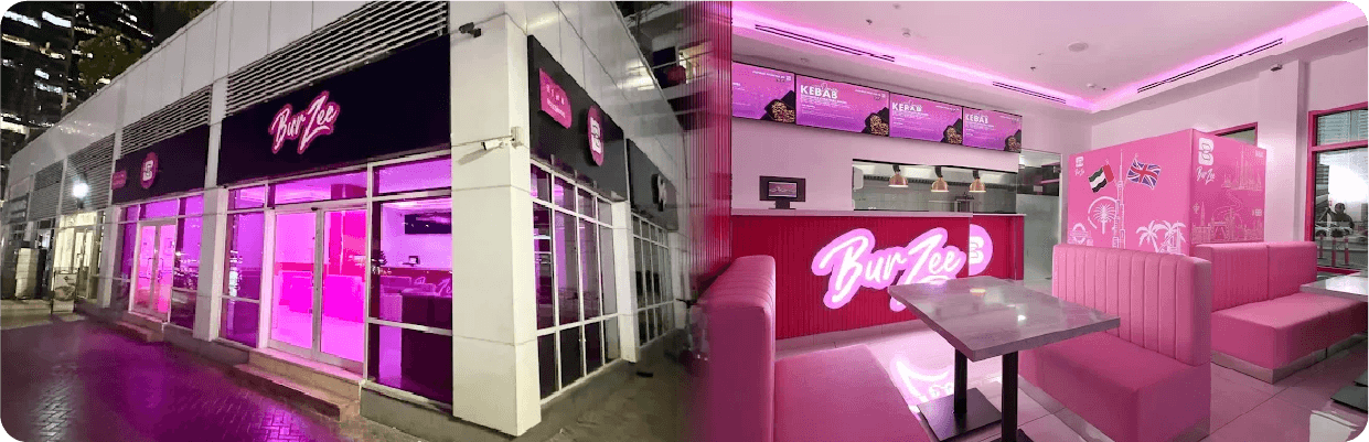 A pink restaurant adorned with a bright pink neon sign, highlighted in the Burzee design and branding case study.