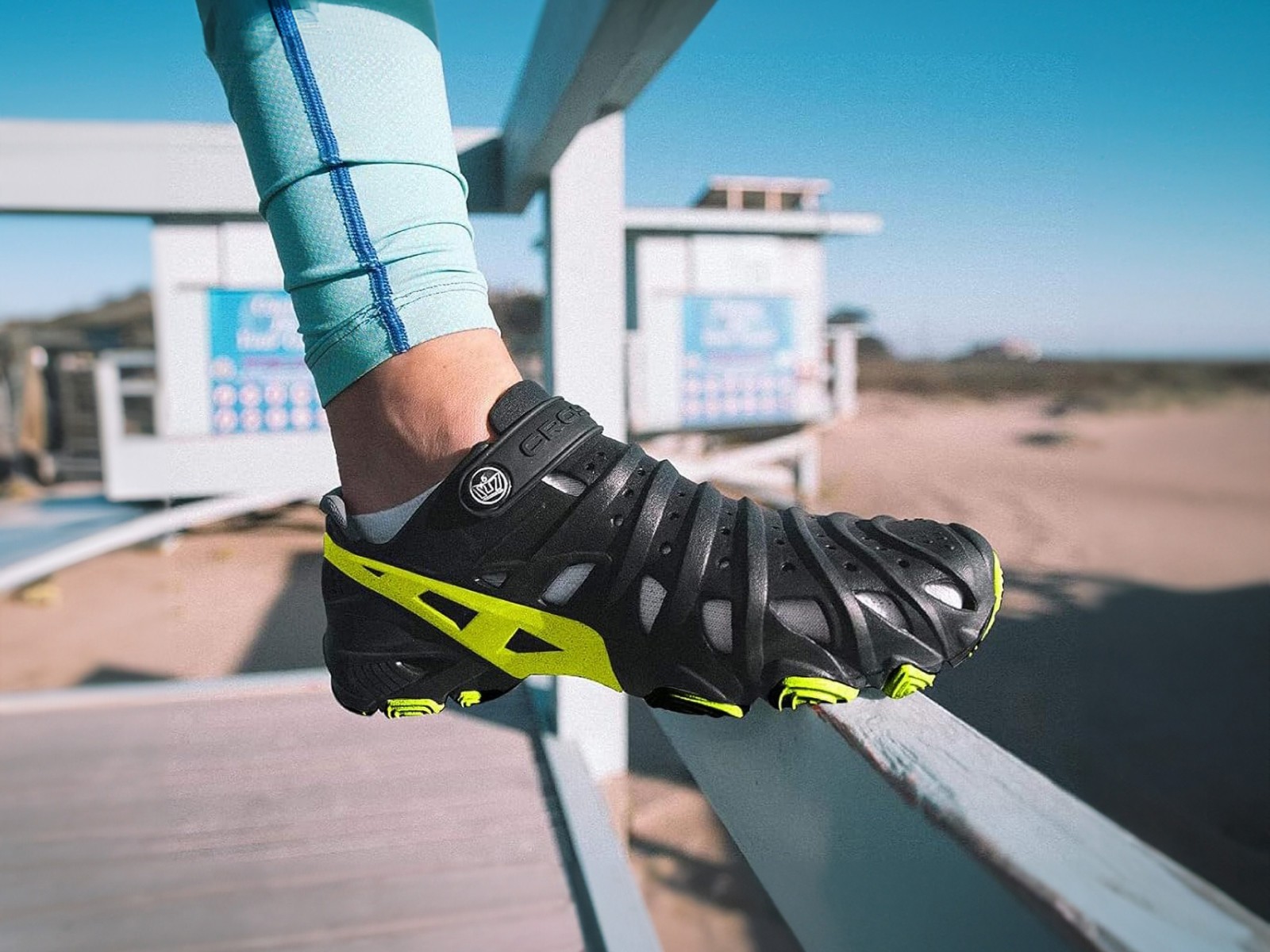 Close-up of a person's hand wearing a sport glove or fitness gear, photographed outdoors with what appears to be exercise equipment visible.