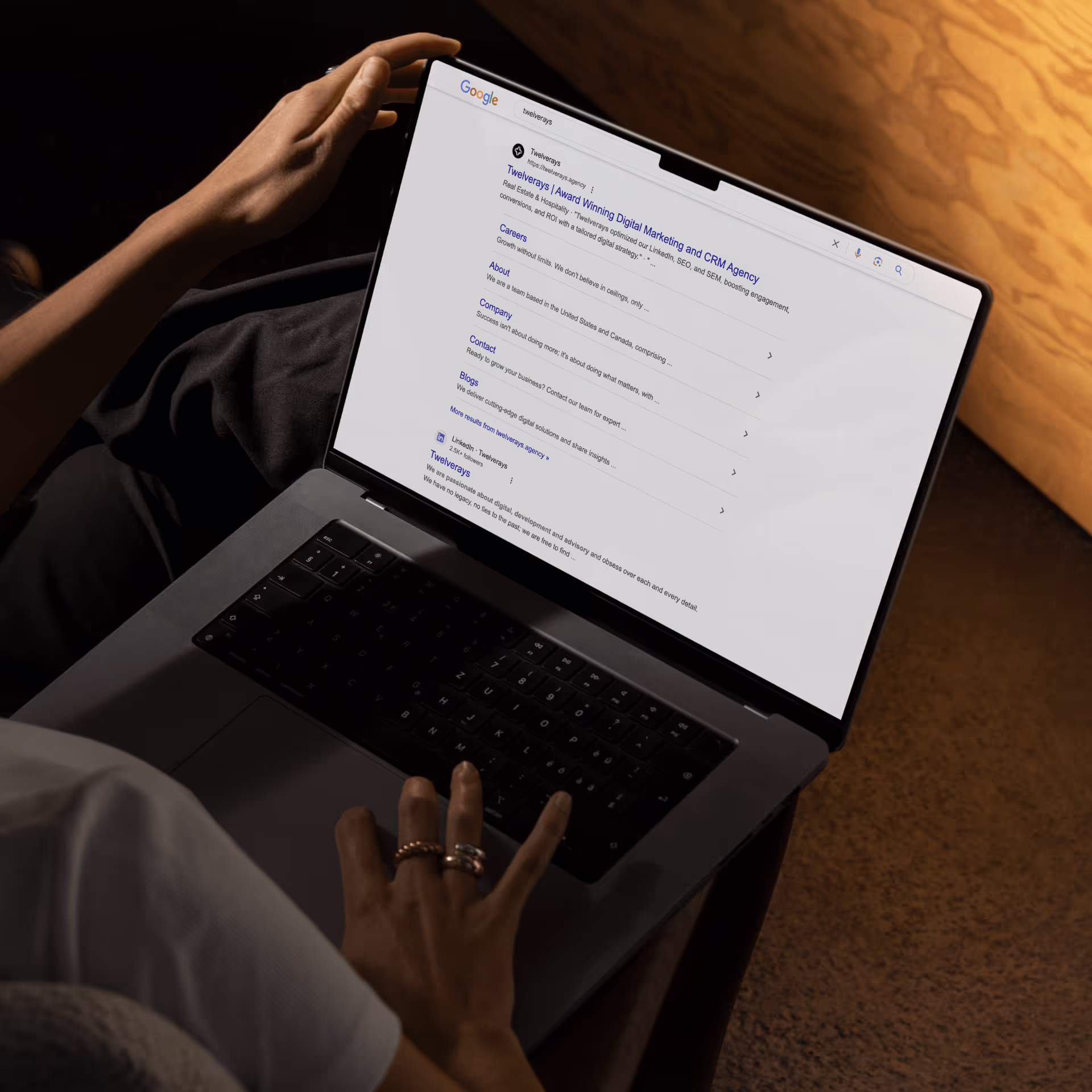 Person working on a laptop in a dark office
