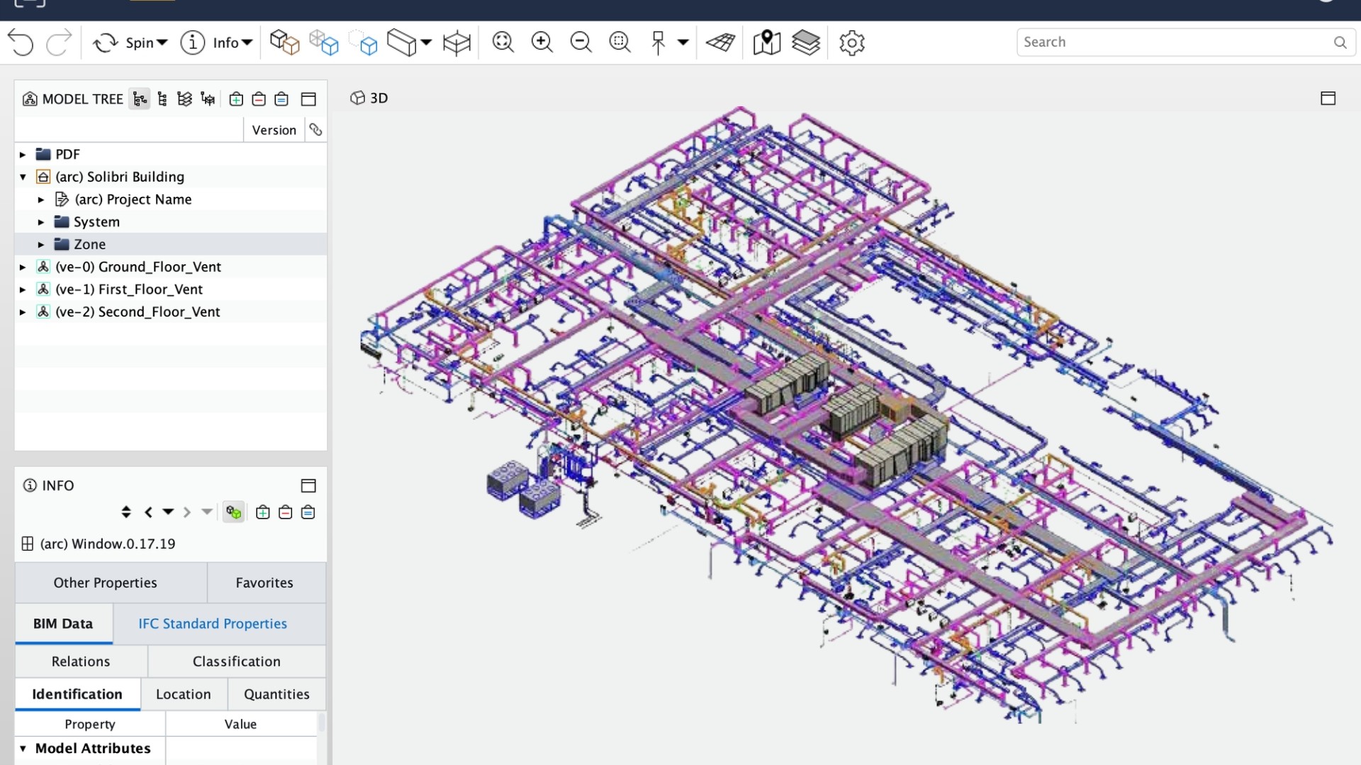A man stands while two people sit at a table in an office setting, smiling and engaged in conversation. The mood is friendly and collaborative.