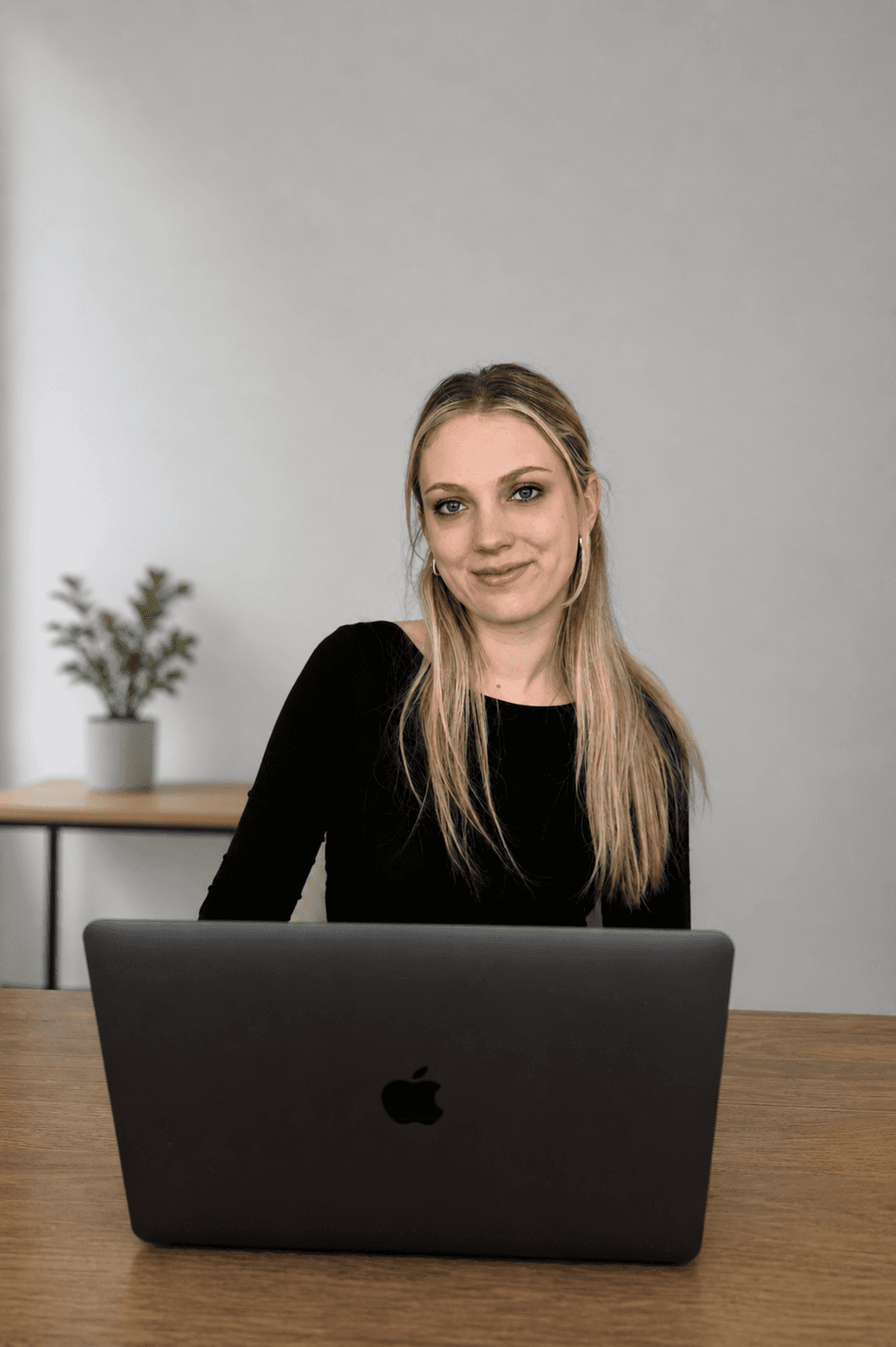 Two coworkers at desk in meeting taking notes