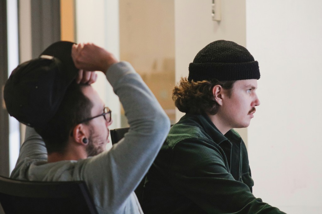 Two people are sitting in the office, discussing the upcoming project.