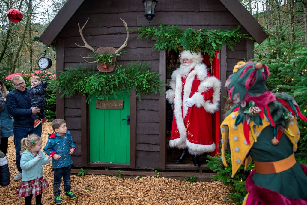 A Santa at an event spreading cheer.