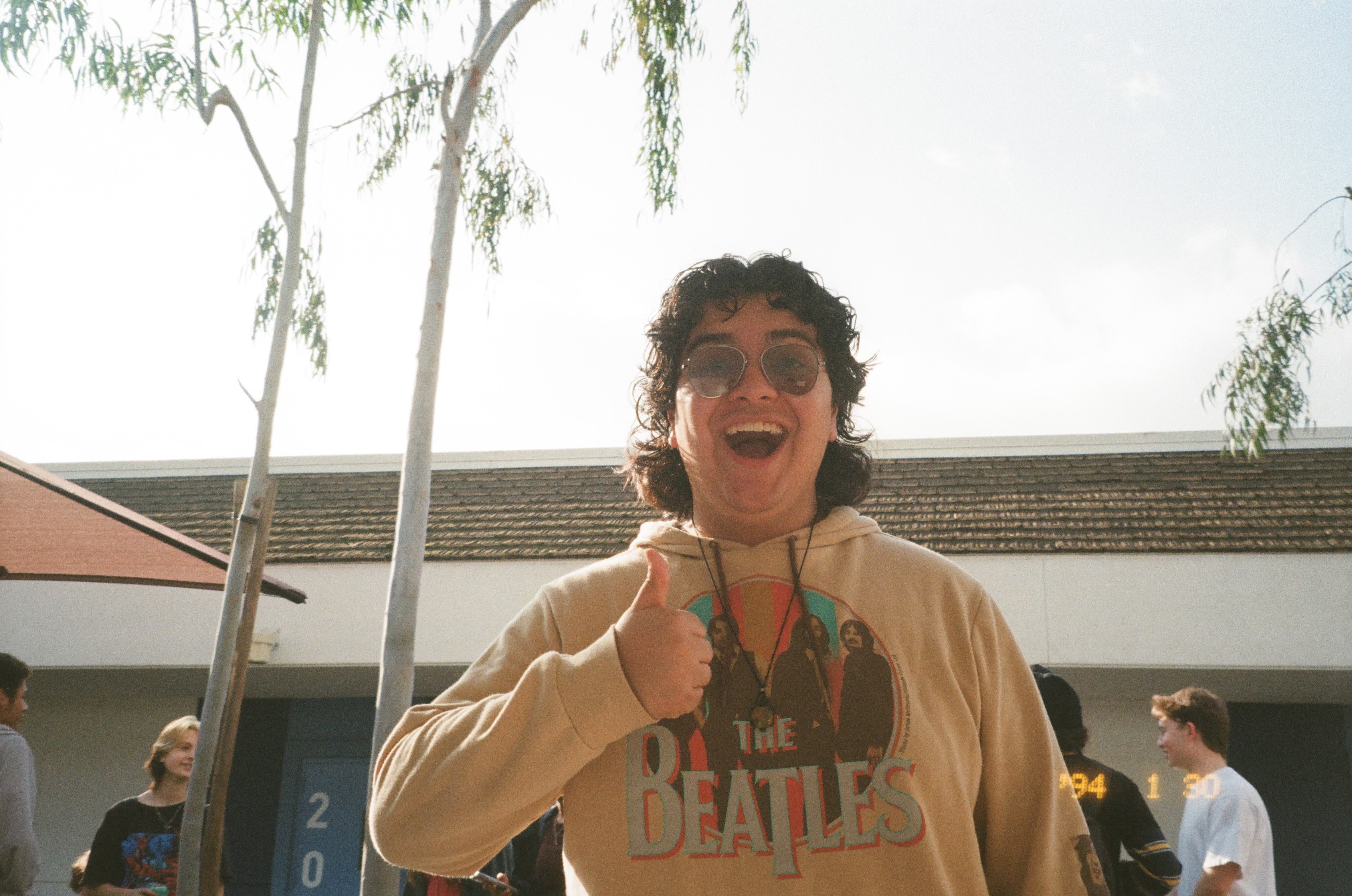 Teen boy laughing dramatically in hoodie in Claremont CA | FFotos