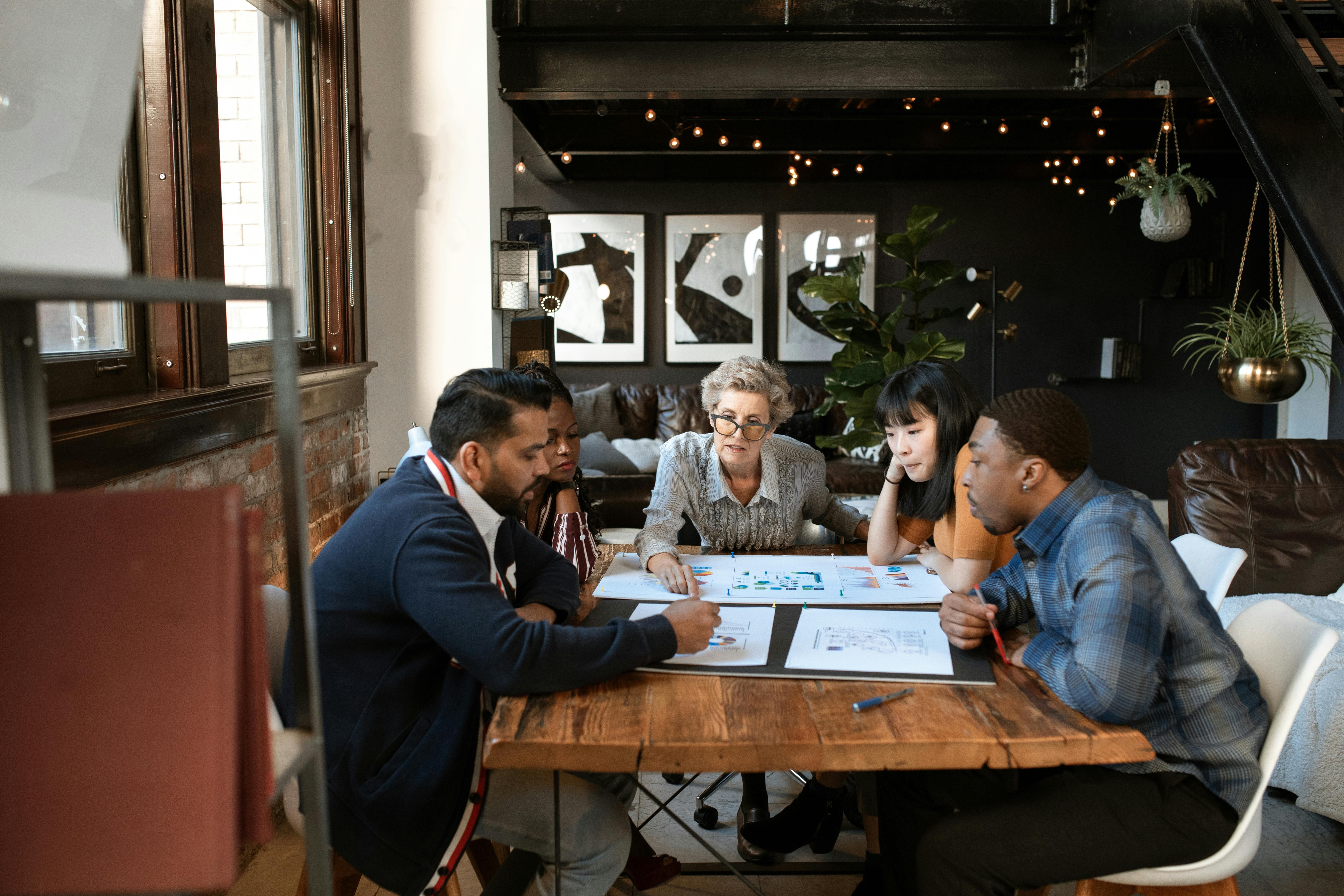 People in a meeting discussing 5 key stages of outreach