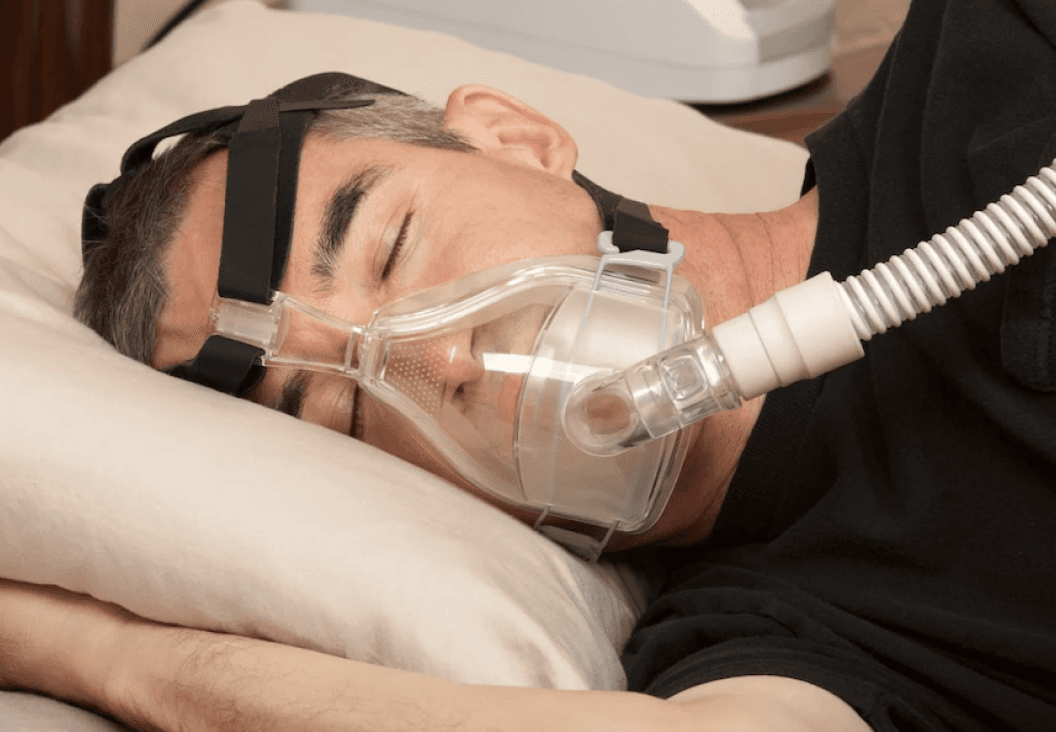 man wearing CPAP mask during sleep to manage sleep apnea