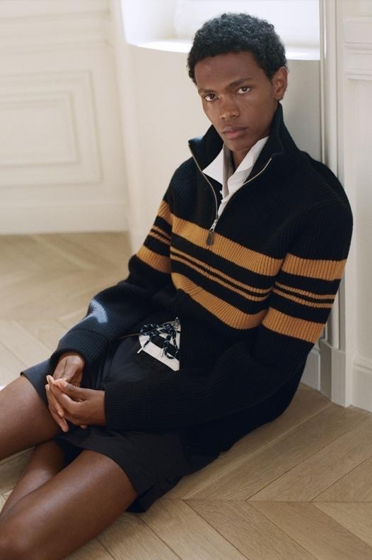 Image may contain Clothing Knitwear Sweater Person Sitting Face and Head