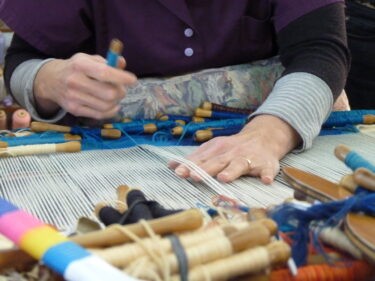 brown and white concrete house near green trees during daytime
