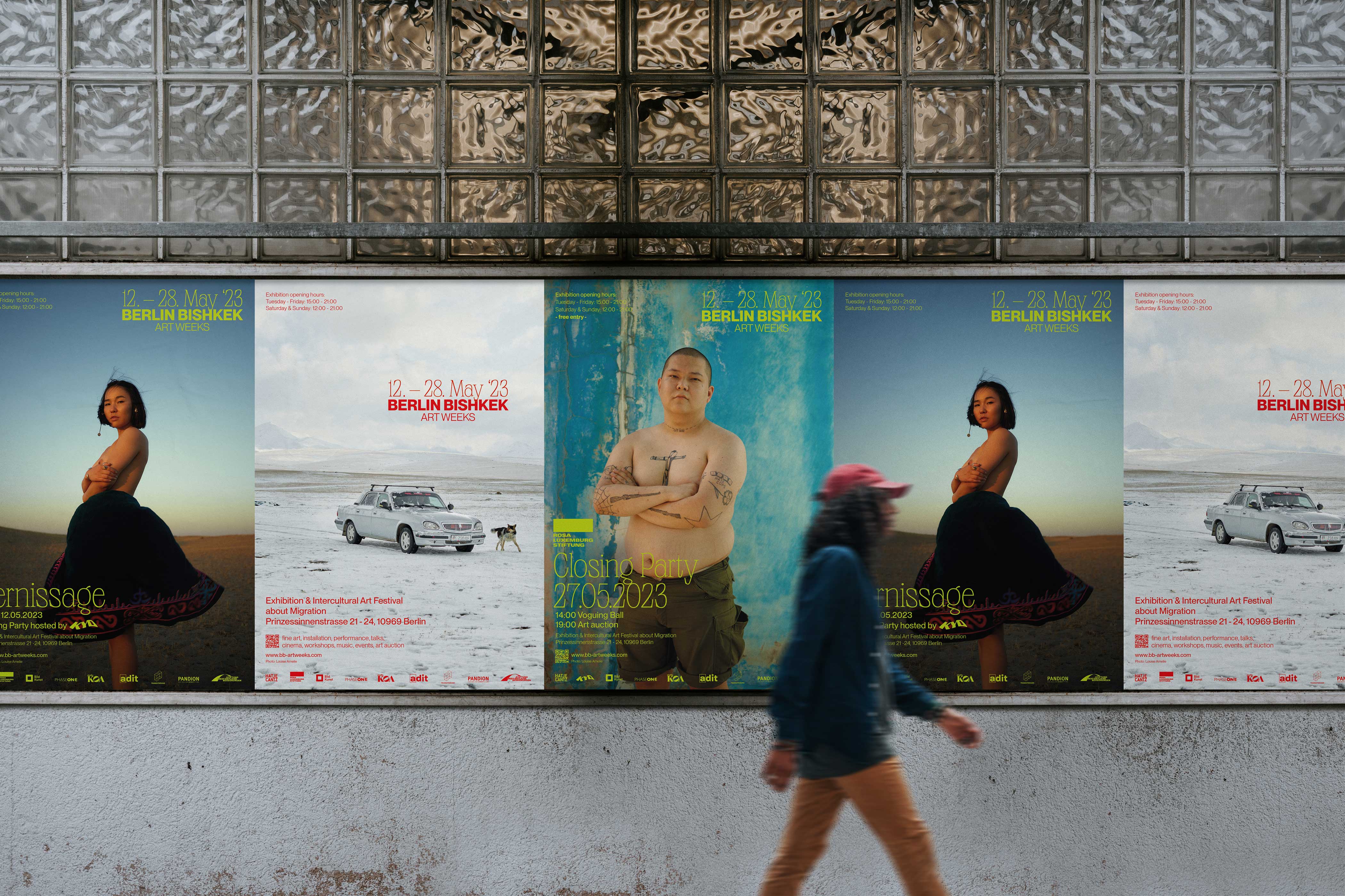 Person walking by poster advertisment for Berlin Bishkek Art Weeks 