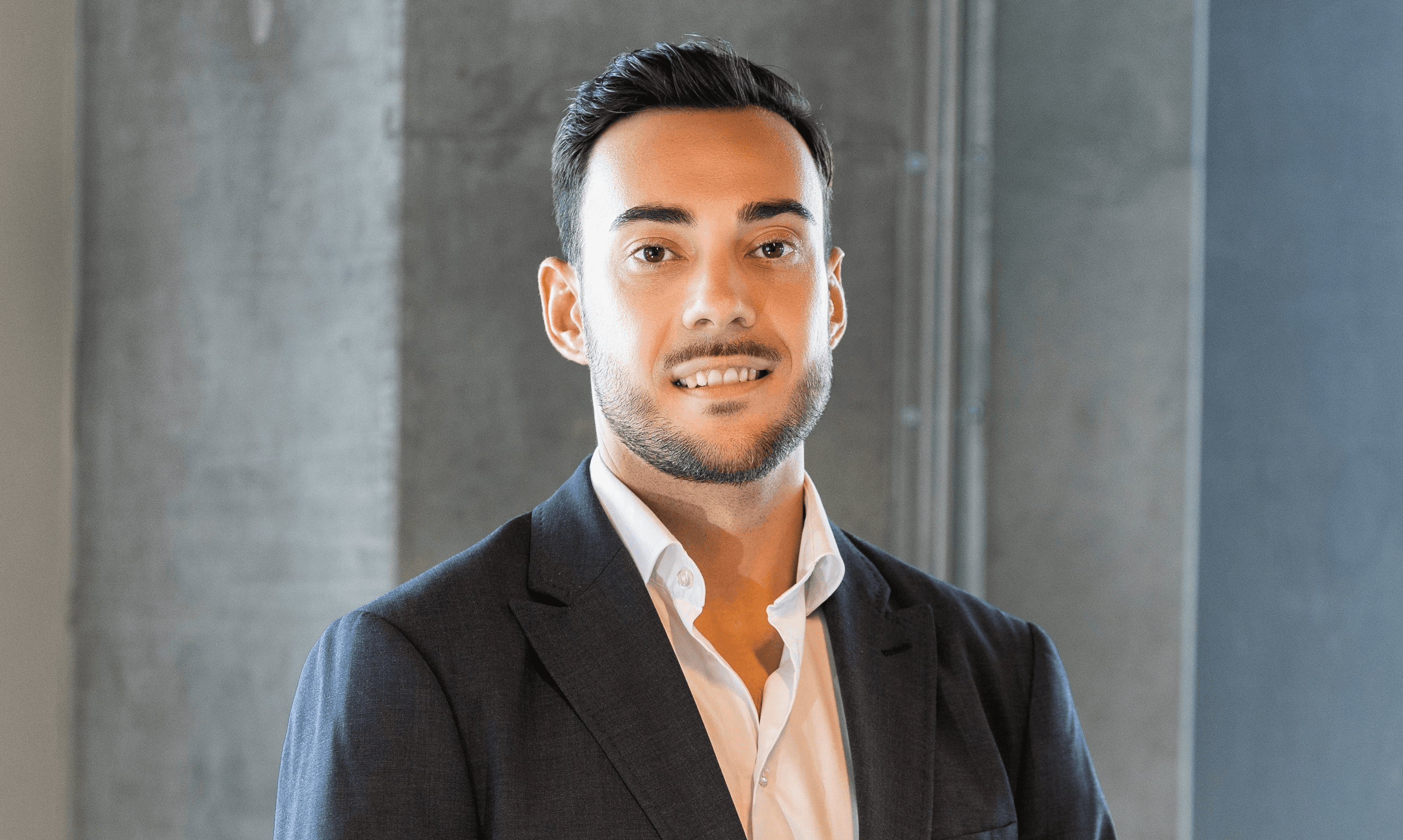 a man in a suit standing in a room