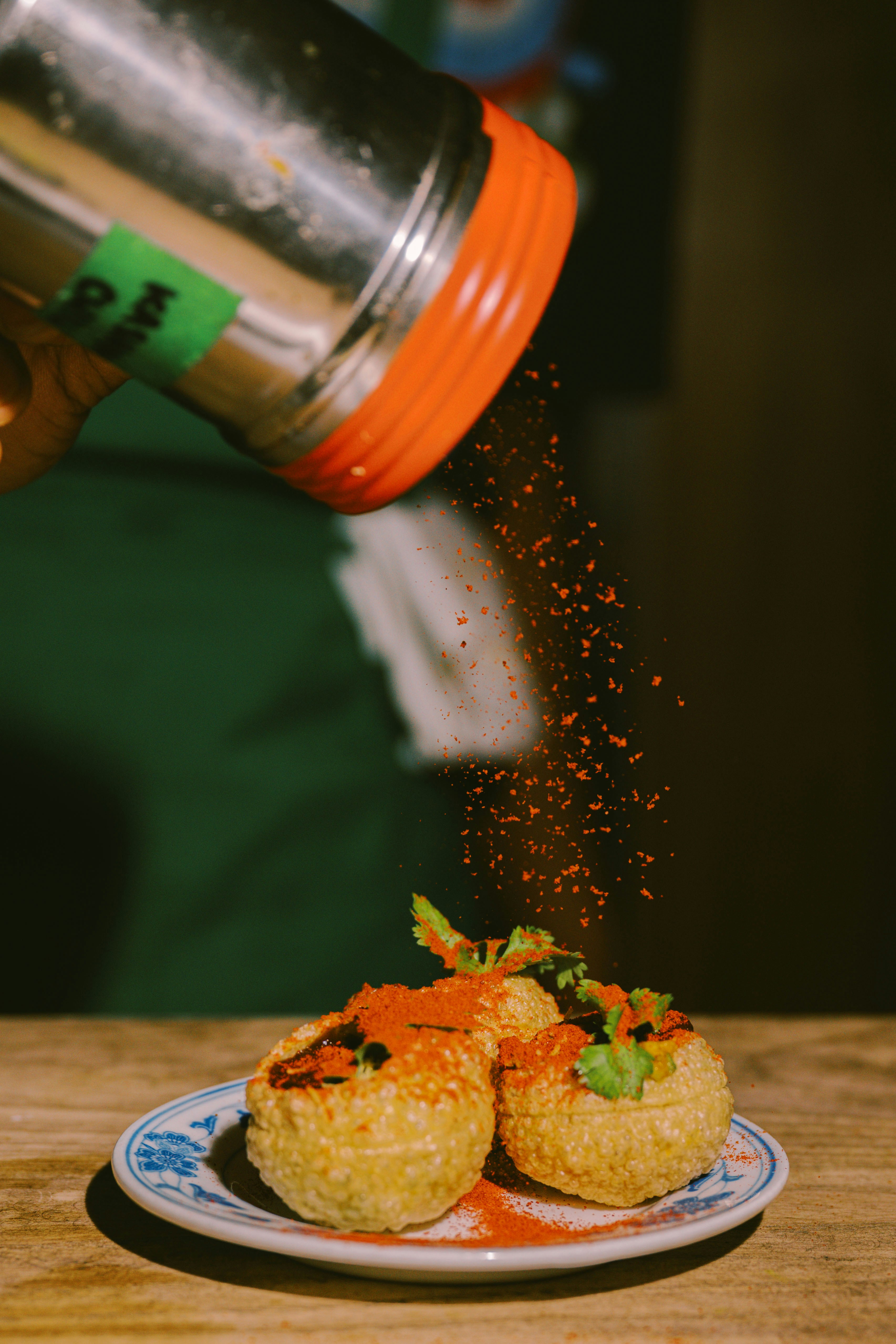 Sprinkling spice on a dish