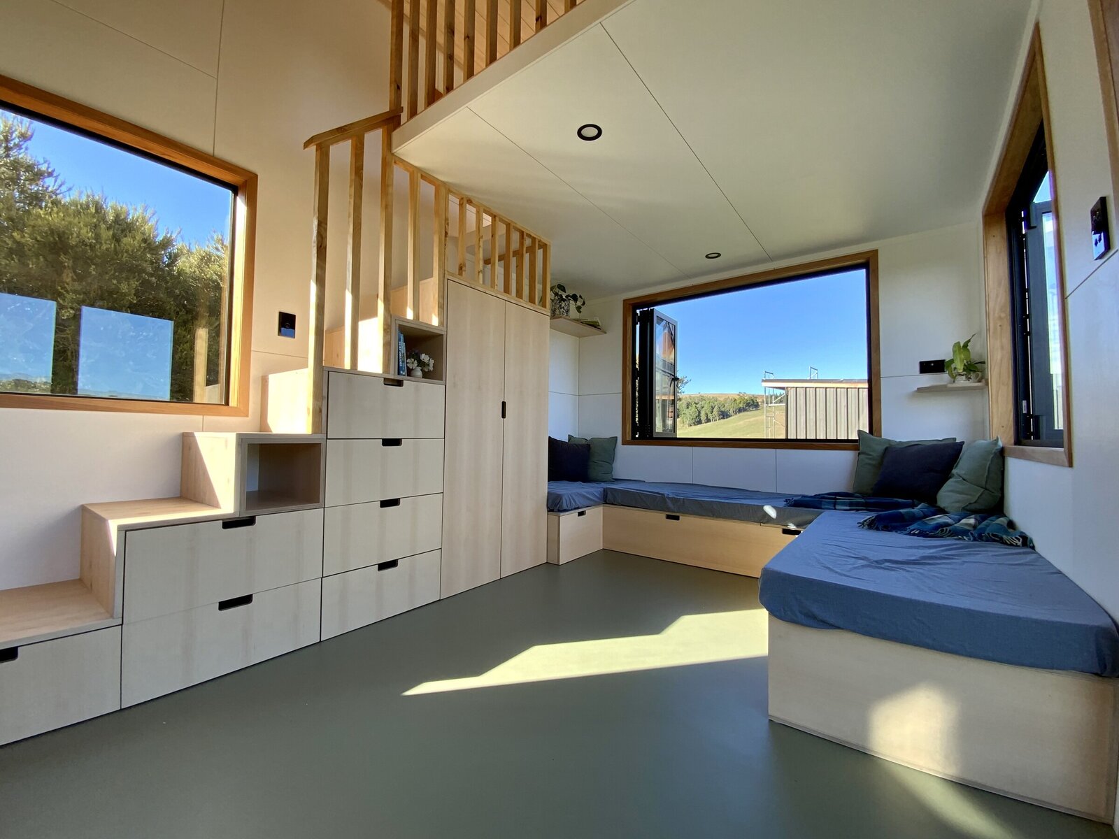 Tiny House living room with storage stairs - Raglan Tiny Homes