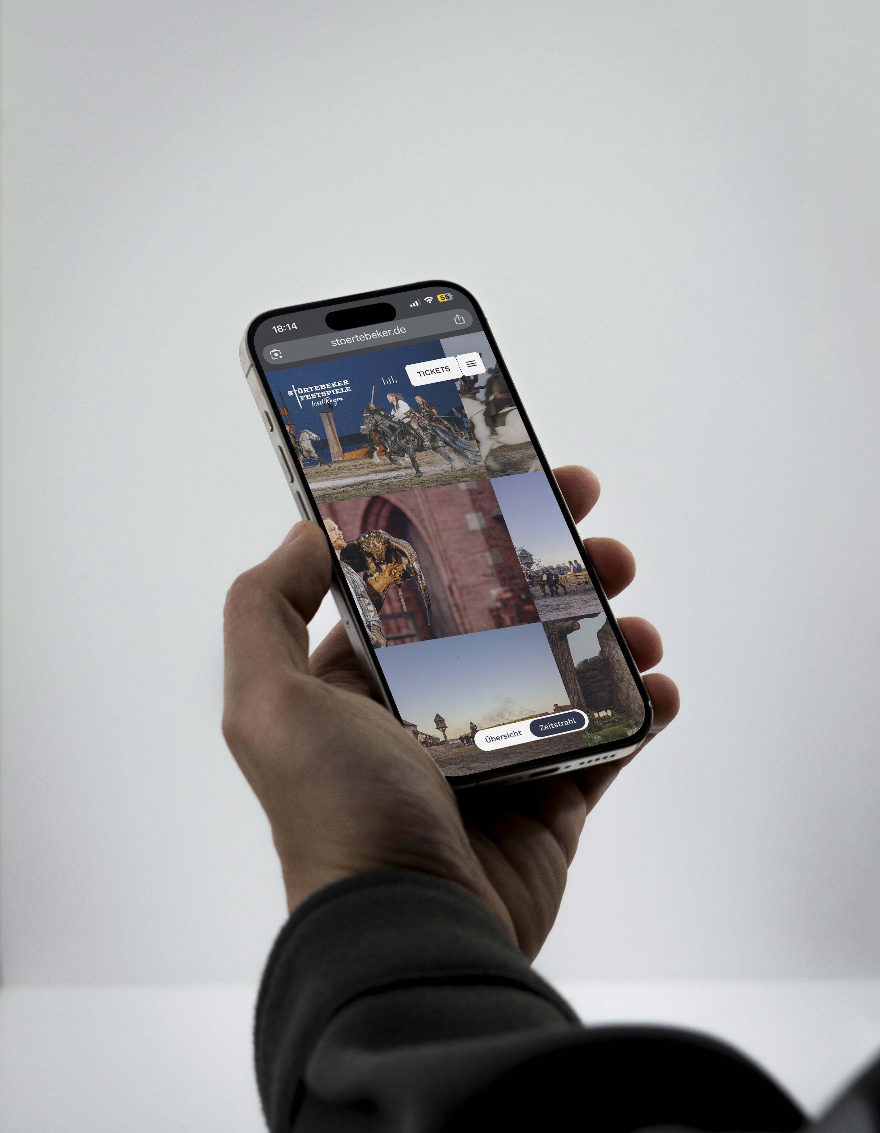 Smartphone in einer Hand mit der mobilen Website der Störtebeker Festspiele und einer Collage aus Bühnenszenen.