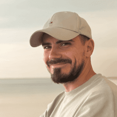 A smiling man in an outdoor landscape