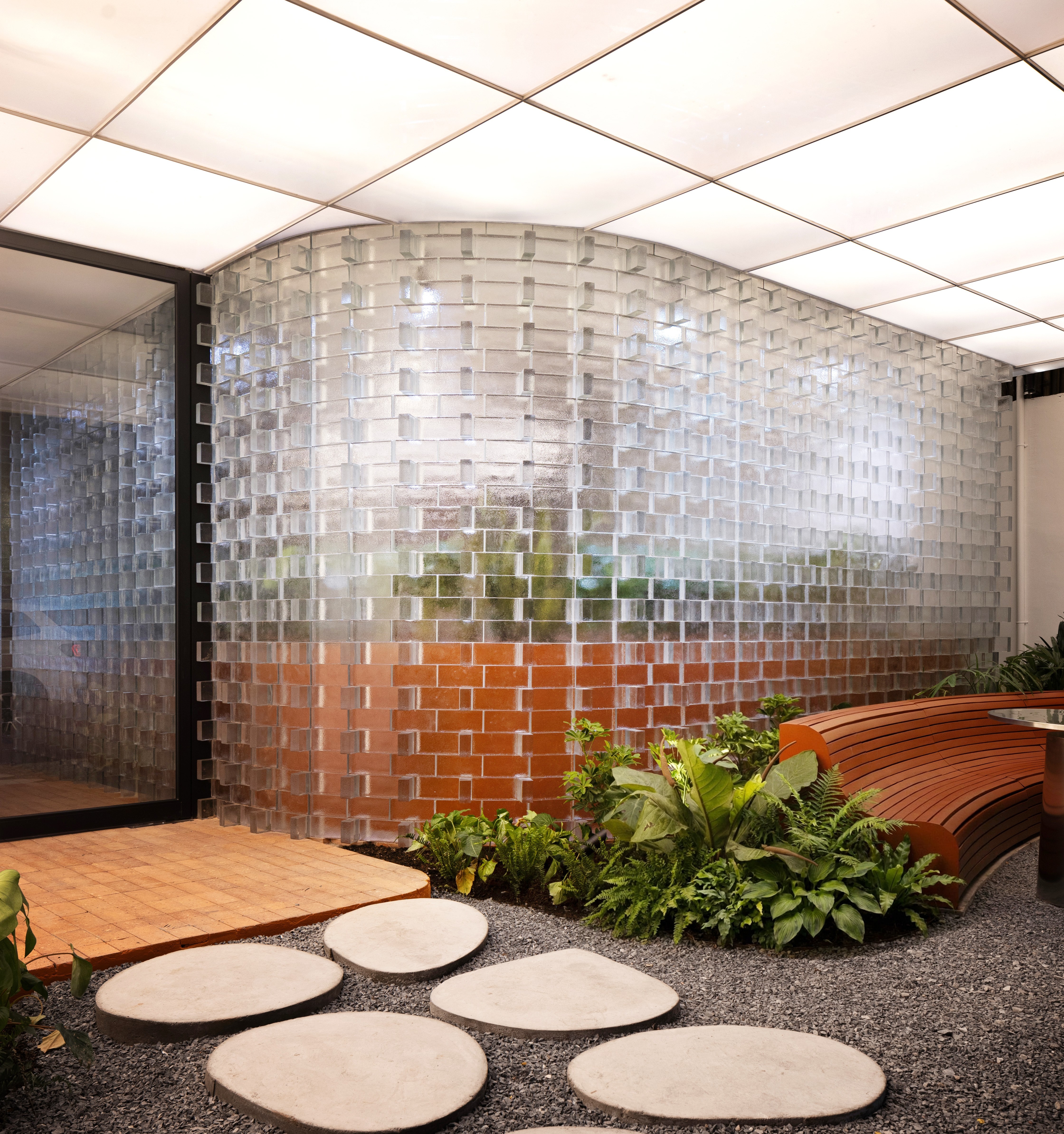 Translucent glass block plant wall detail, textured glazing that transmits light while concealing a planted layer