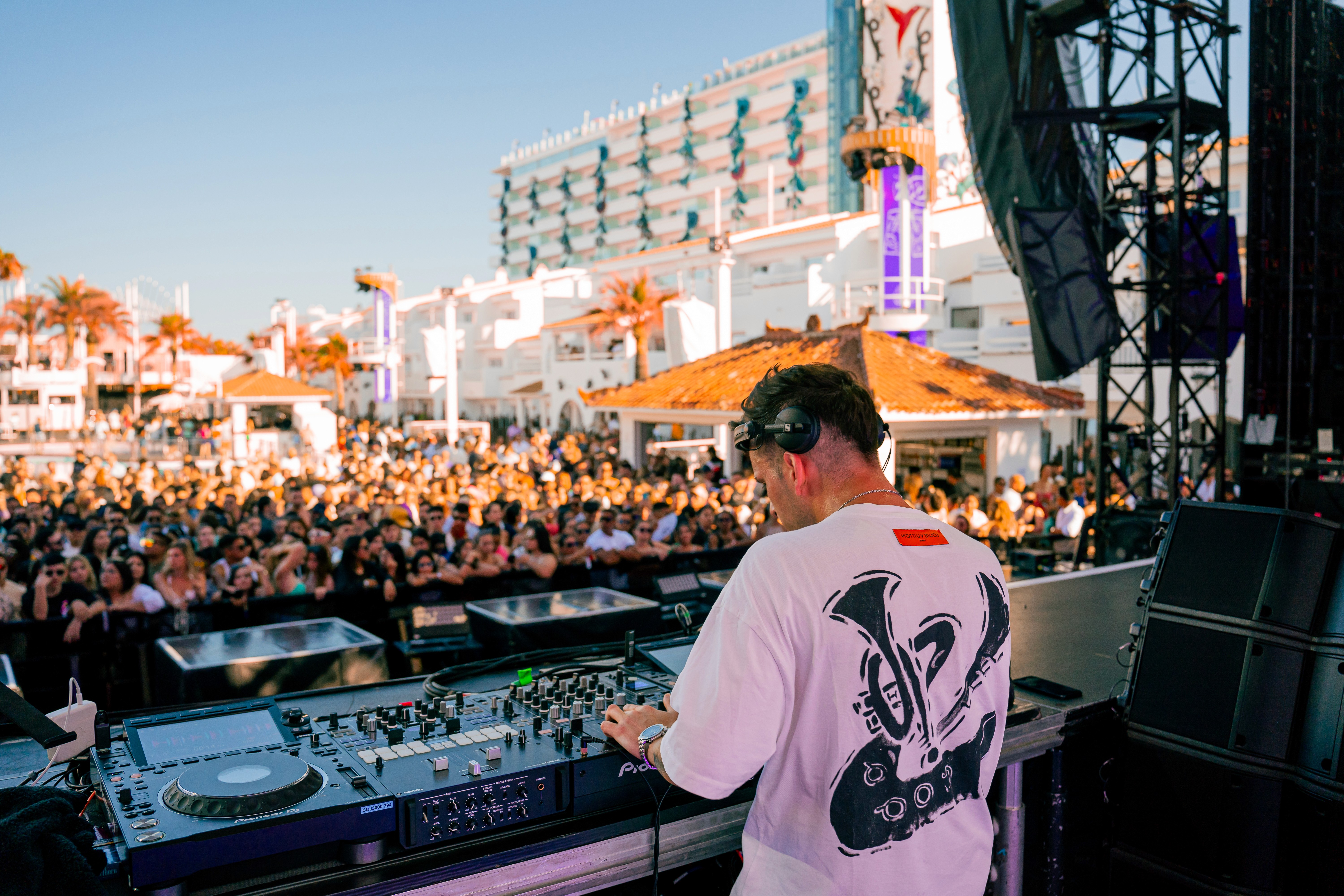 Two men wearing yellow and black face masks, standing side by side, with neutral expressions on their faces.