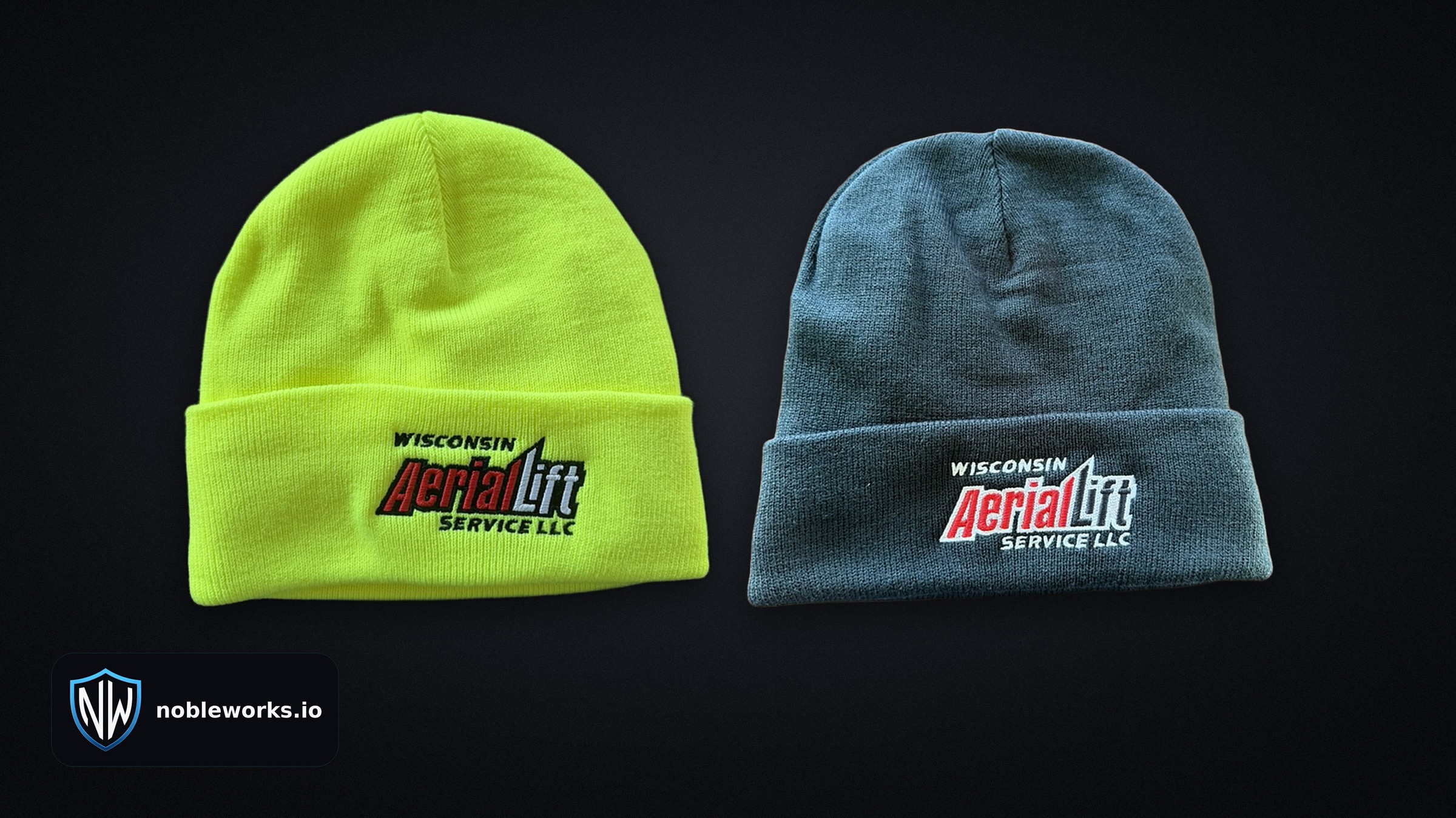 Two winter hats side by side on a dark background, one safety yellow and one black, with the NobleWorks badge.