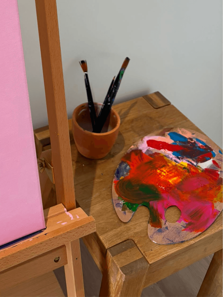 The artist doing oil painting in his studio.