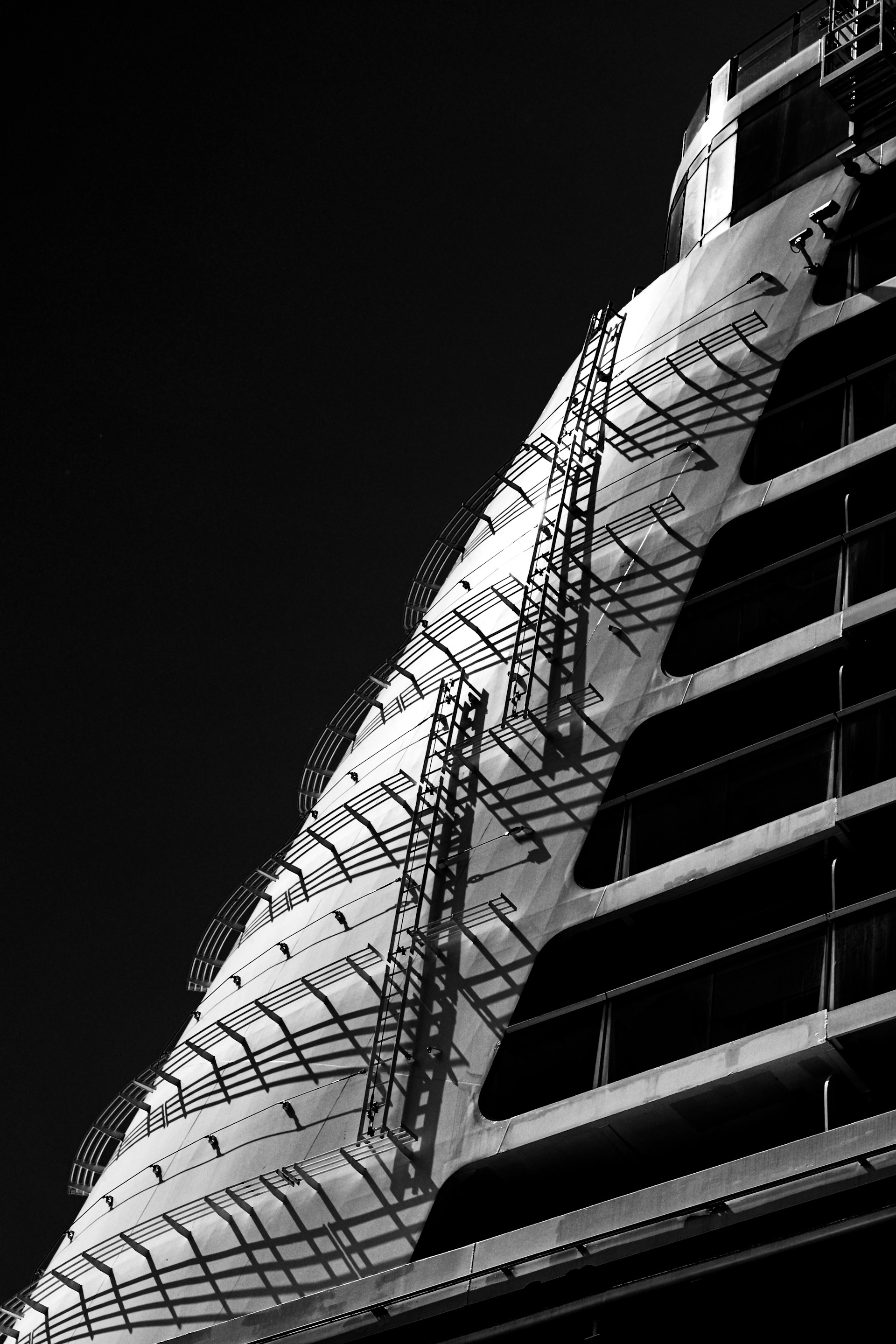 A dramatic, low-angle shot of the bow of a modern cruise ship against a clear sky. The sharp lines and massive scale serve as a metaphor for the structural integrity and momentum required to "ship" complex digital projects and overcome the deprioritization trap.