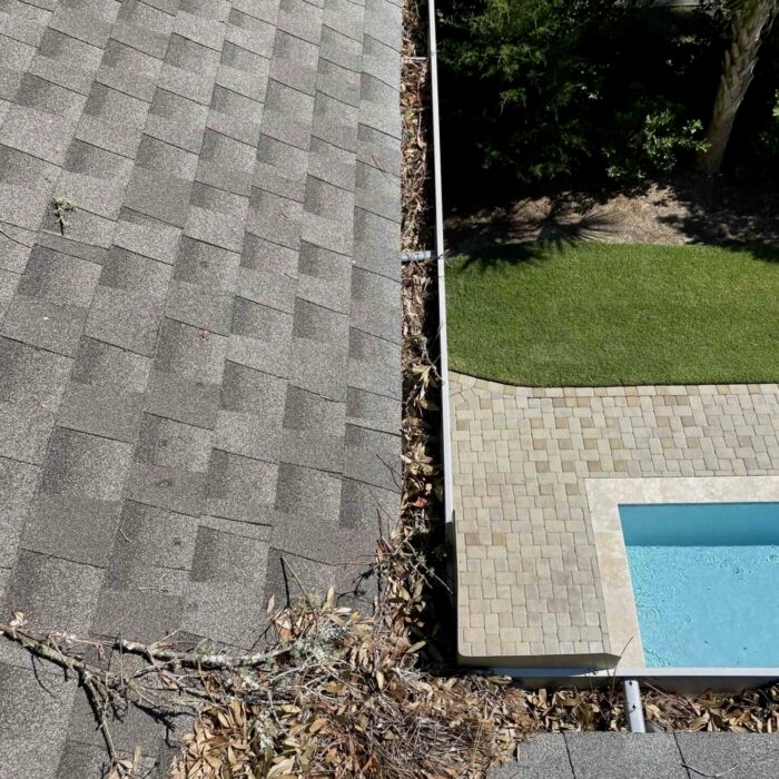 Before and after—gutter cleaned in Hilton Head SC, clear water flow restored after debris removal.