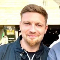 smiling woman wearing white and black pinstriped collared top